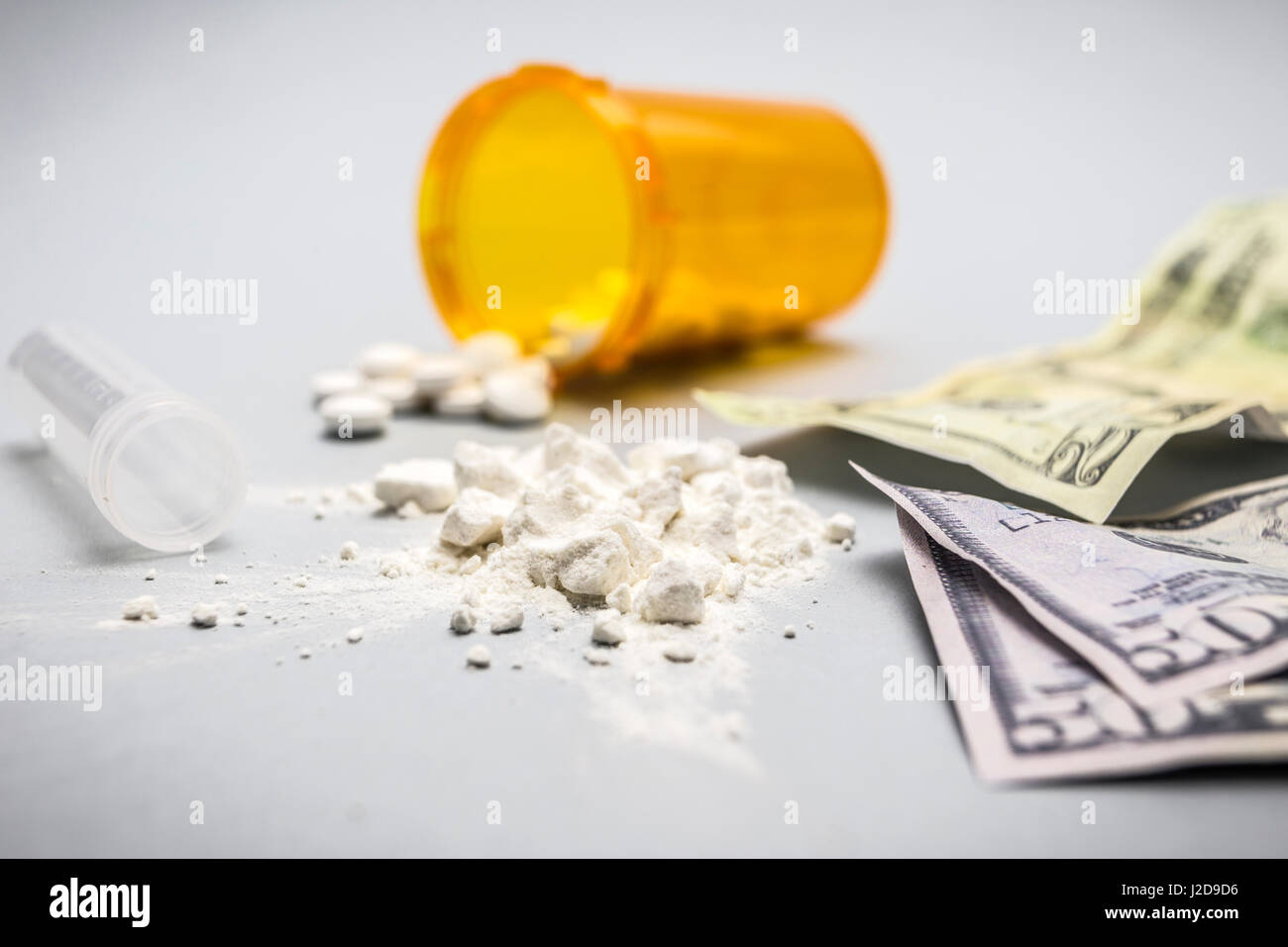 Cocaine drug powder pile along with several dollar tickets Stock Photo