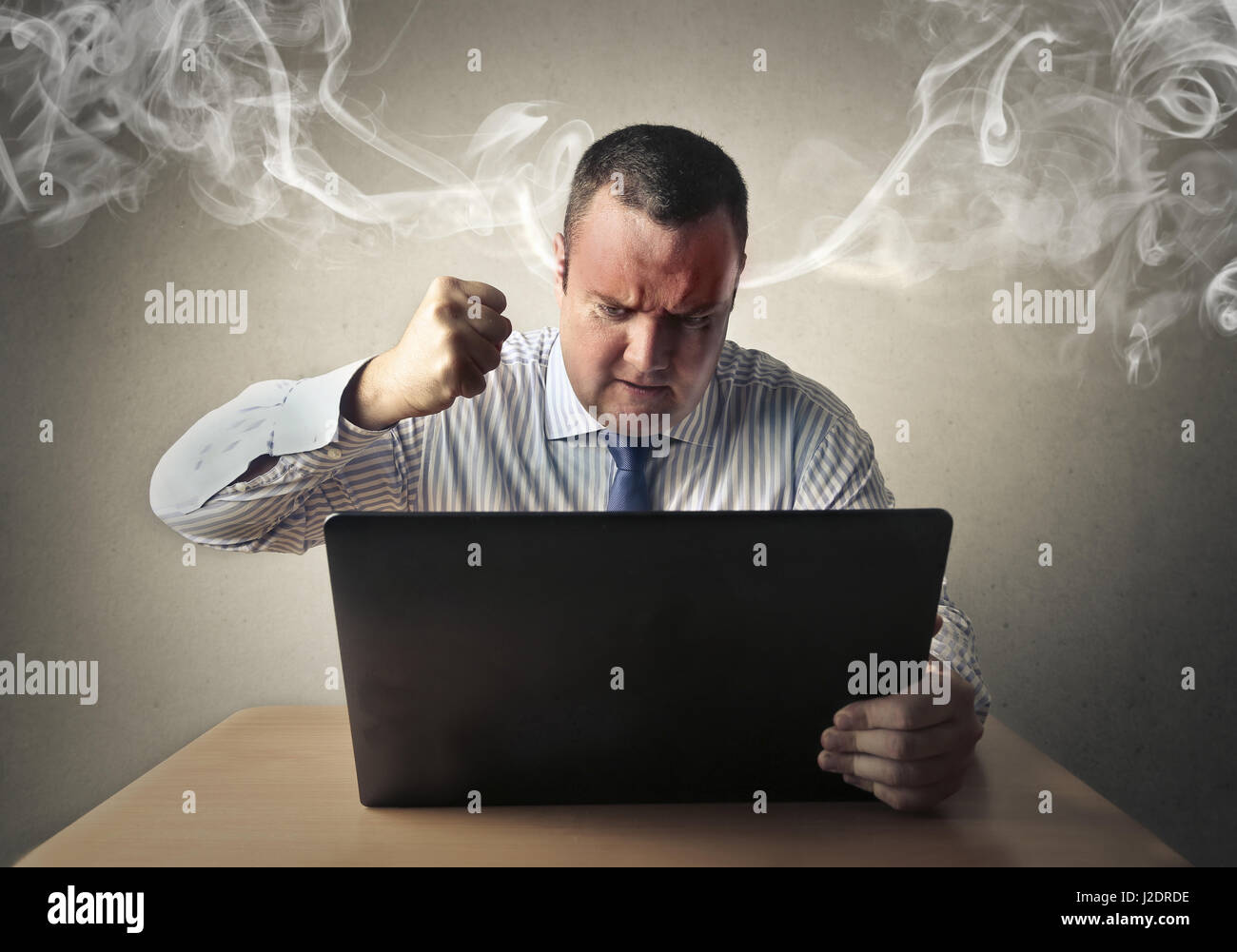 Businessman with steam coming out of his ears Stock Photo