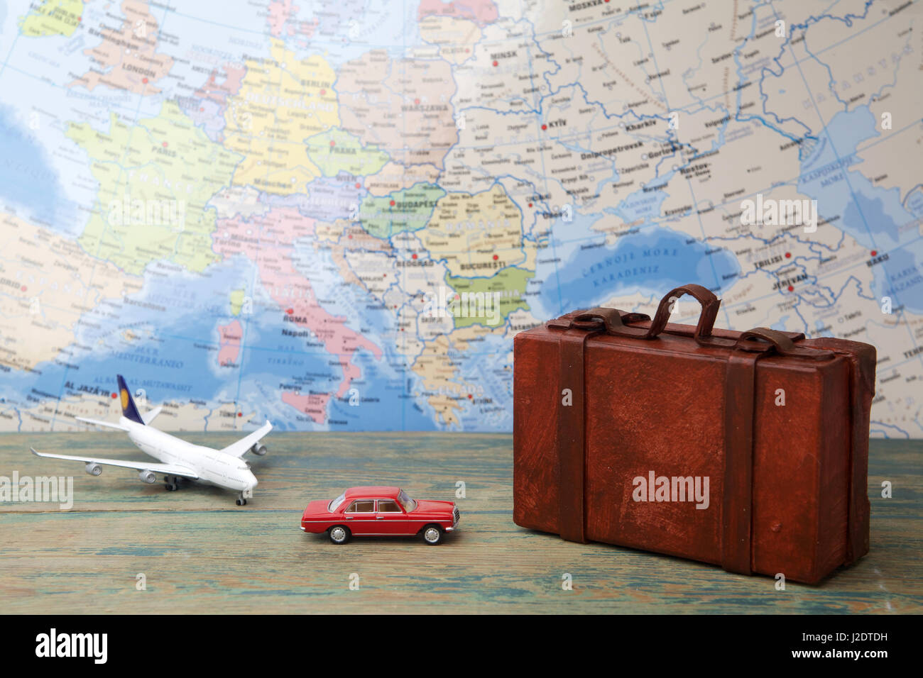 Trip or traveling by airplane concept. Miniature toy airplane, car and