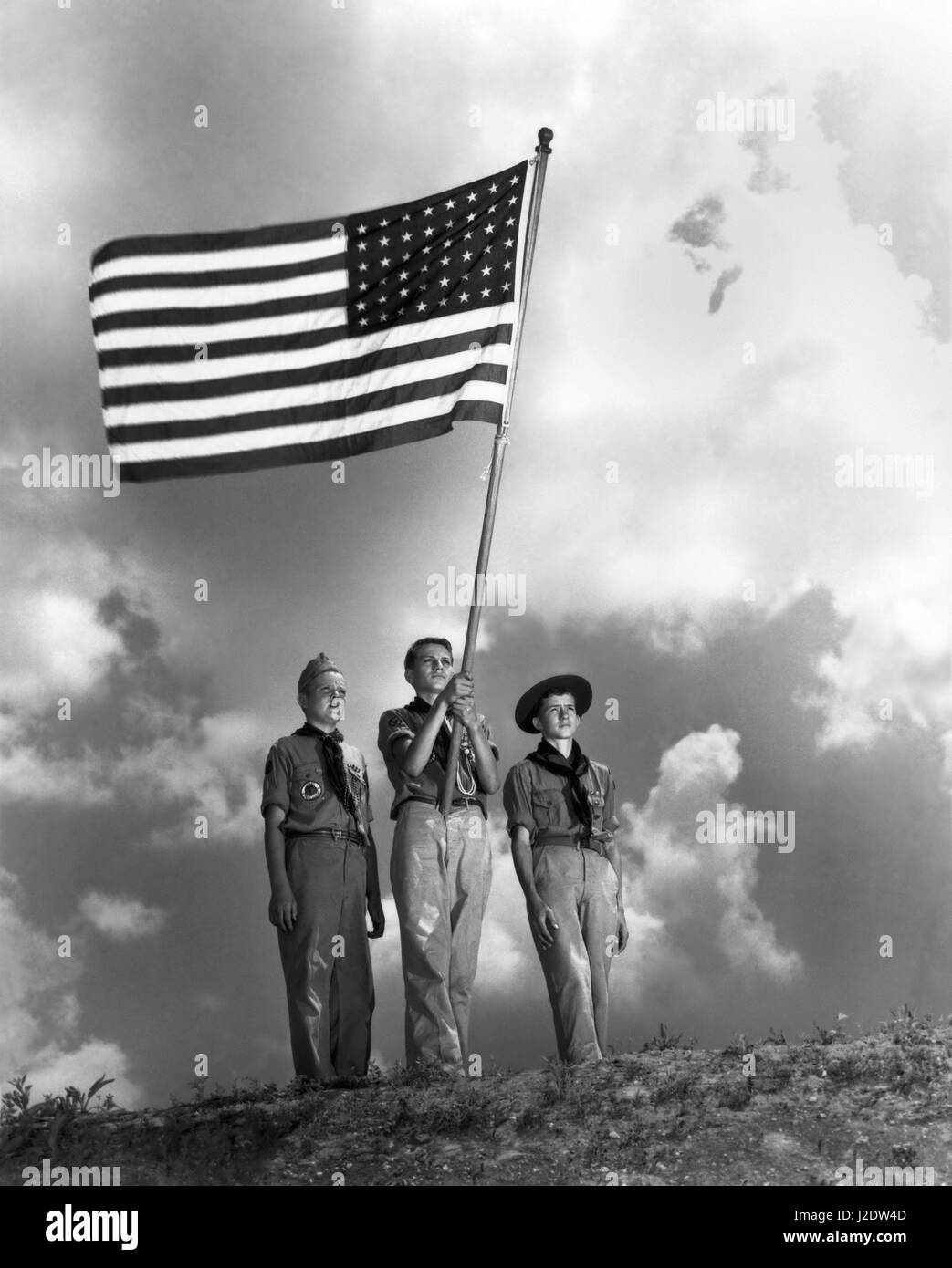 Boy Scouts Henry King, Bill Trimby and Bob Linsay stand with the American flag June 26, 1946 in Oak Ridge,  Tennessee. Oak Ridge was the site of the Clinton Engineer Works where the Manhattan Project to make an atomic bomb was based during WWII. Stock Photo