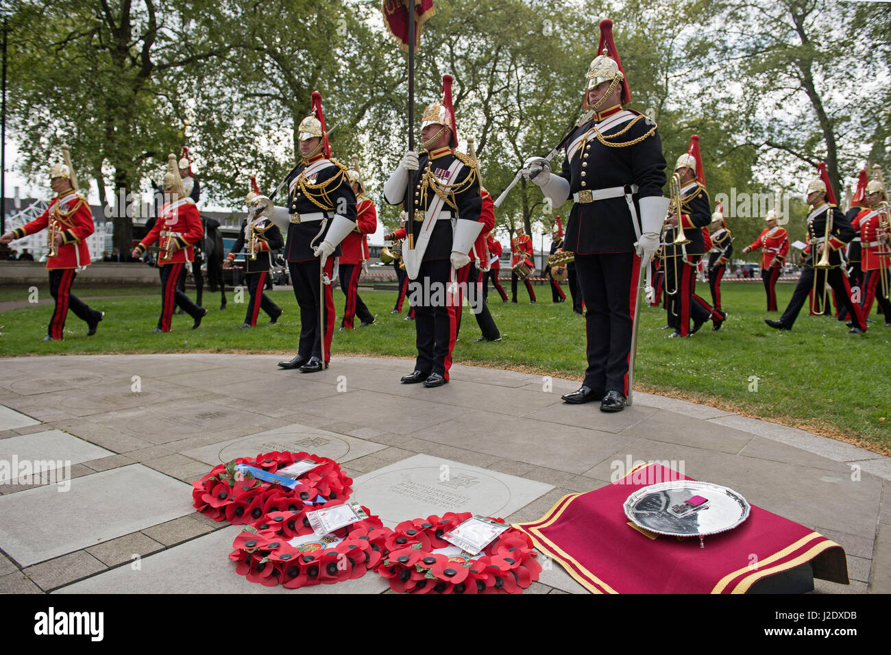 Poppy wreaths are laid at a memorial paving stone in Victoria Embankment Gardens in Westminster, London, during a commemoration event for Second Lieutenant John Spencer Dunville. Stock Photo