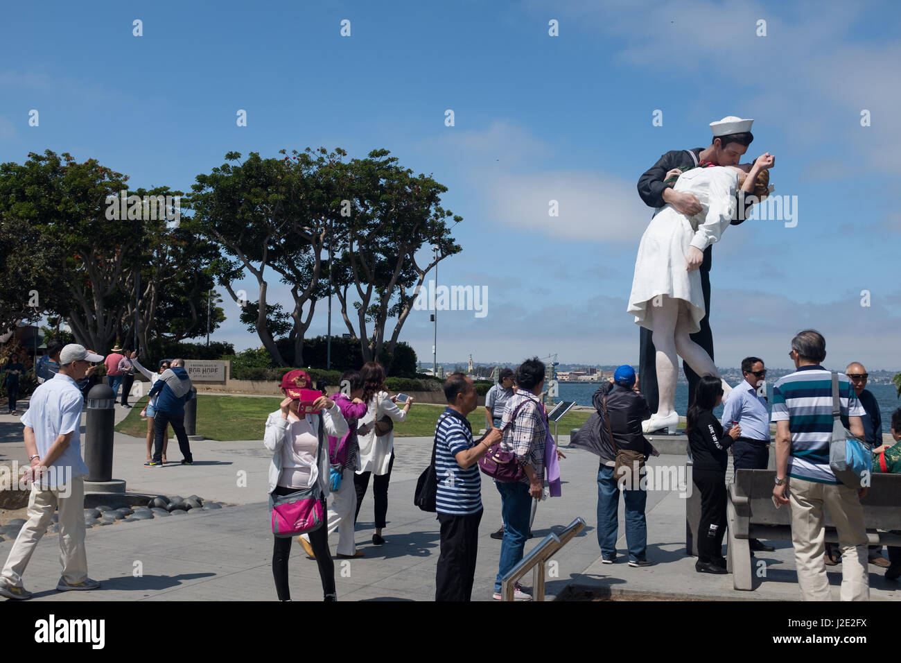 "Unconditional Surrender" sculpture, by Seward Johnson, and USS Midway