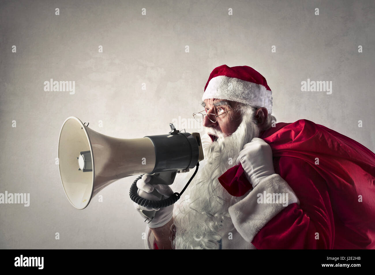 Santa talking with megaphone Stock Photo
