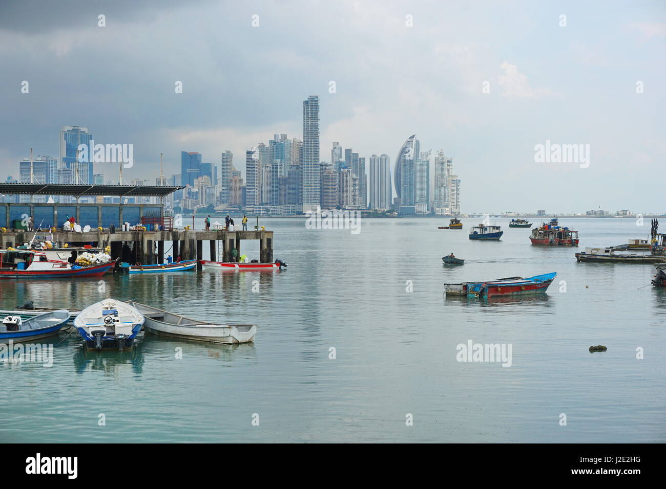 Panama city fishing harbor wharf and boats with skyscrapers buildings in background, Pacific coast of Panama, Central America Stock Photo