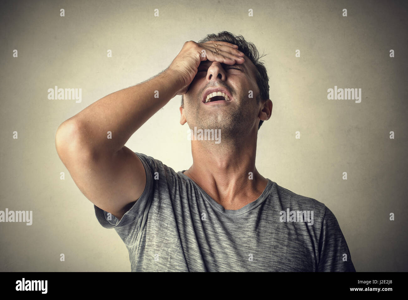 Man being tired and holding his head Stock Photo
