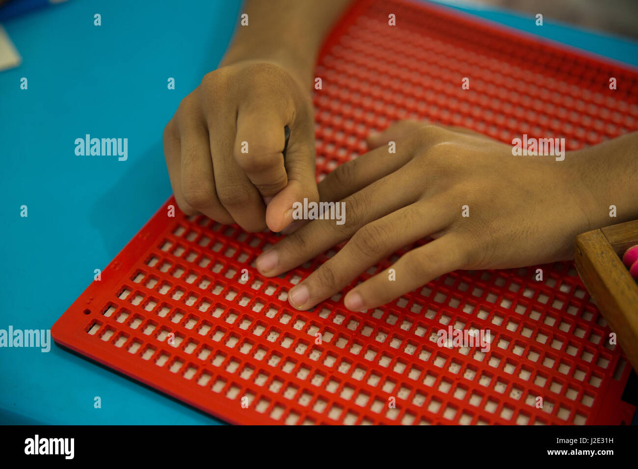 Visually impaired girl student learns in classroom with the help of