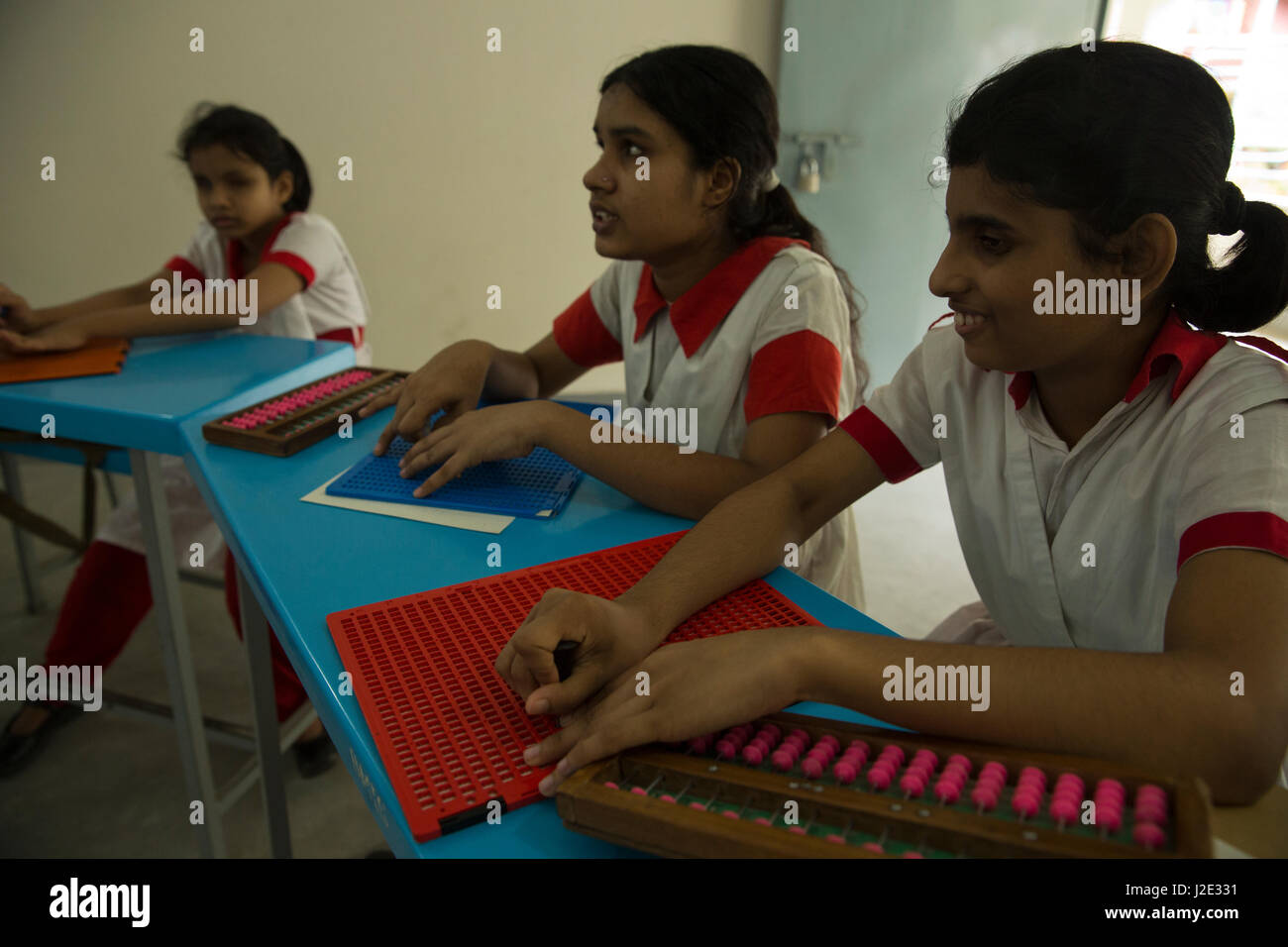 Visually impaired girl students learn in classroom with the help of
