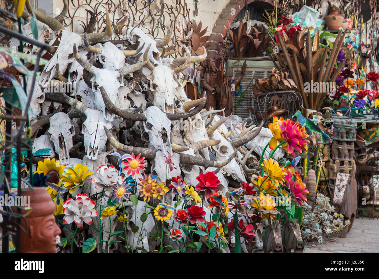 Nogales, Sonora, Mexico - Skulls and flowers on sale at a souvenir shop near the U.S.-Mexico border. Stock Photo