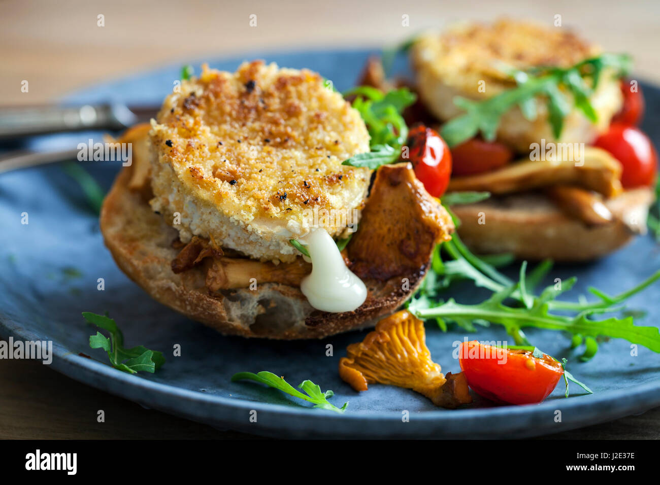 Baked goat cheese on sourdough bread with chanterelle mushrooms and