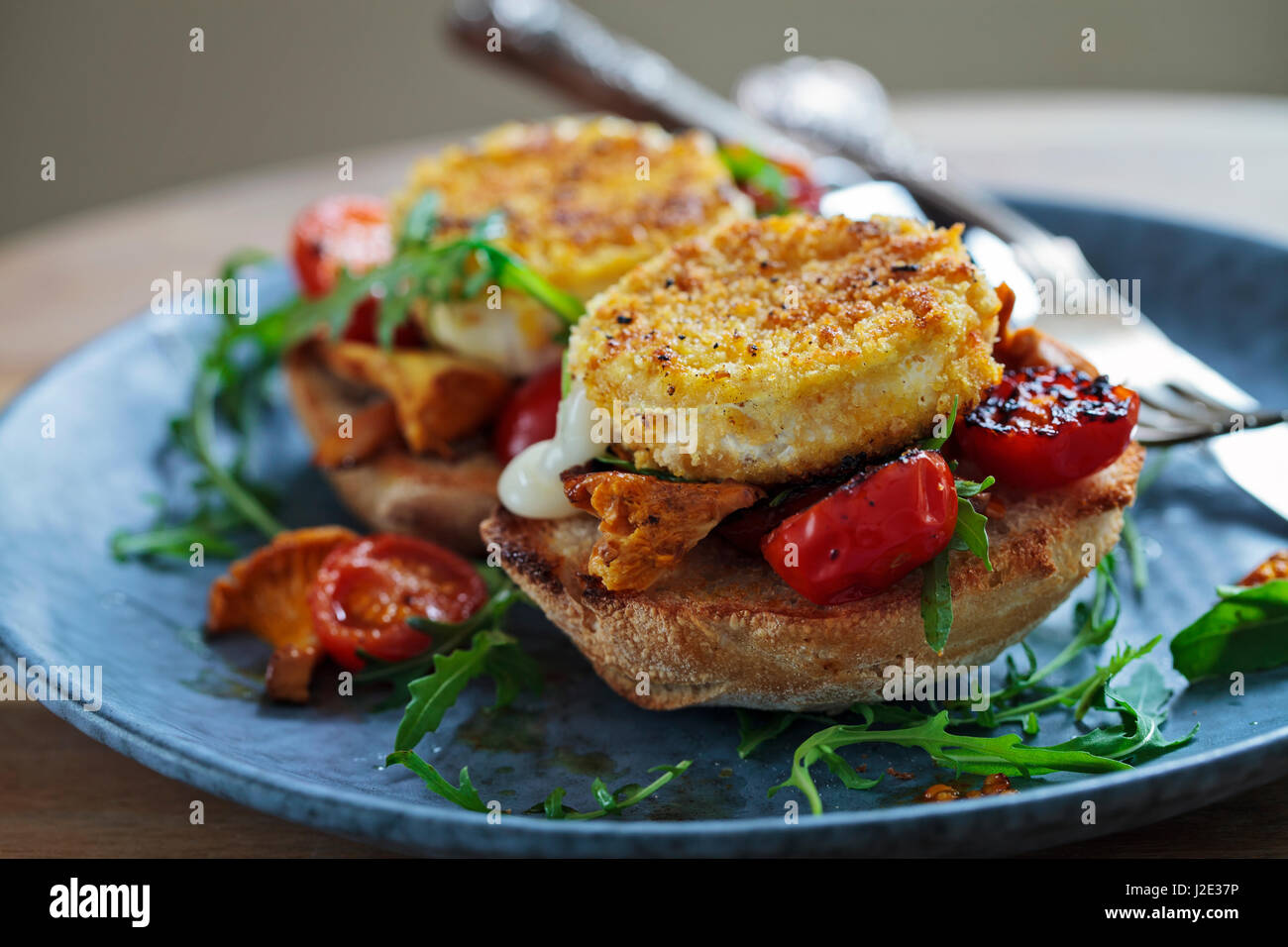 Baked goat cheese on sourdough bread with chanterelle mushrooms and