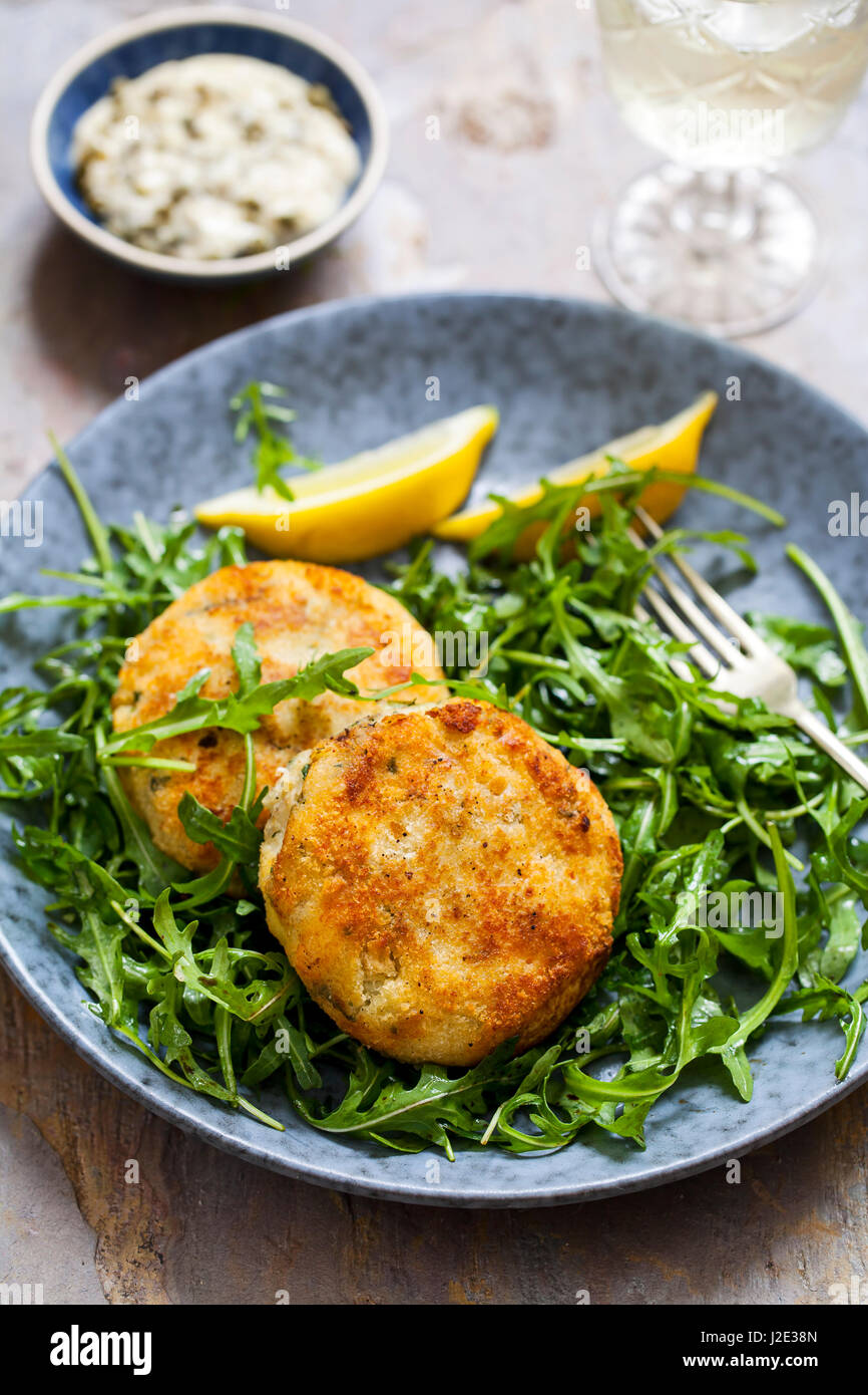 Fish cakes with tartar sauce and rucola salad Stock Photo - Alamy