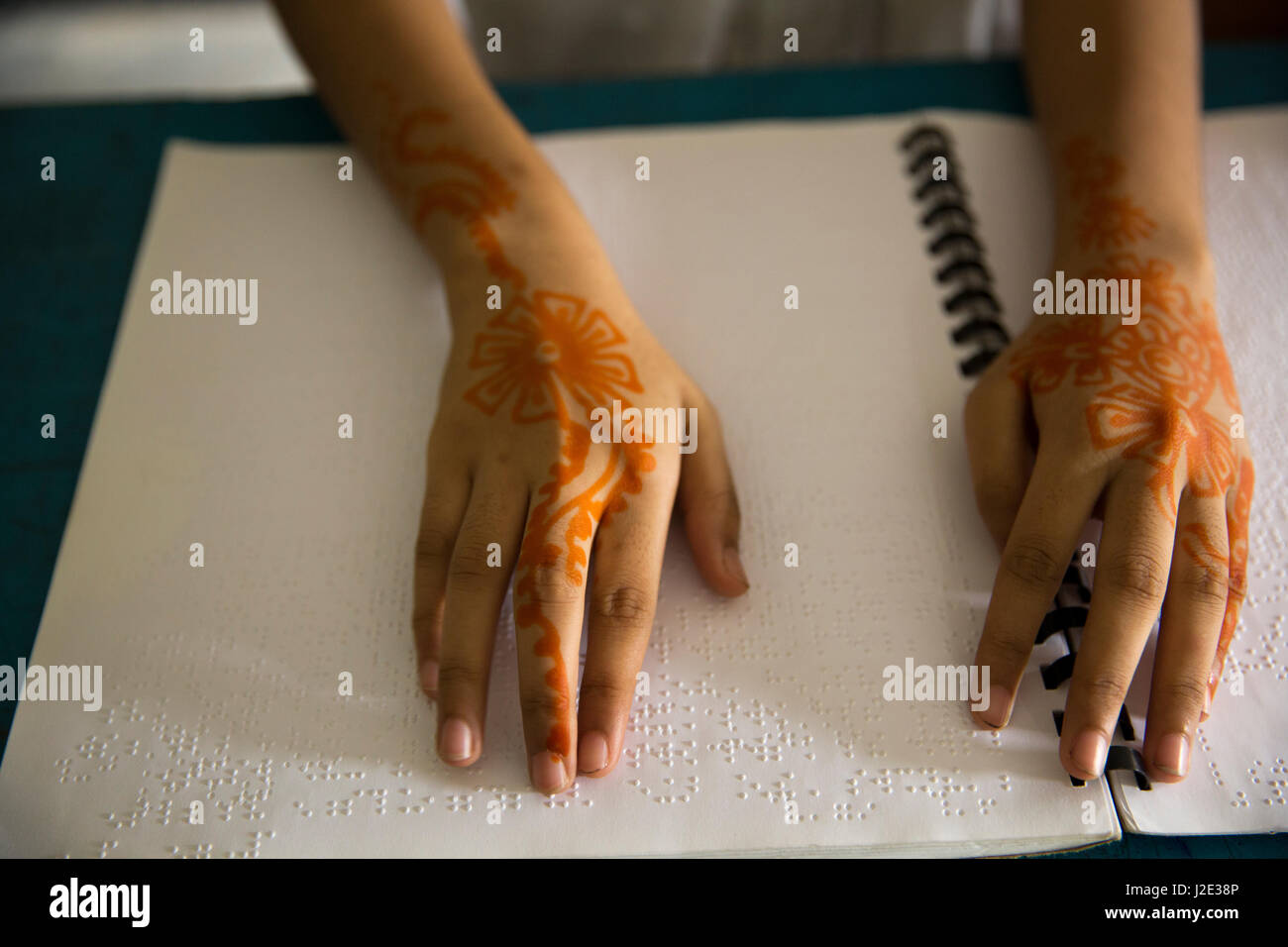 Visually impaired girl student learns in classroom with the help of