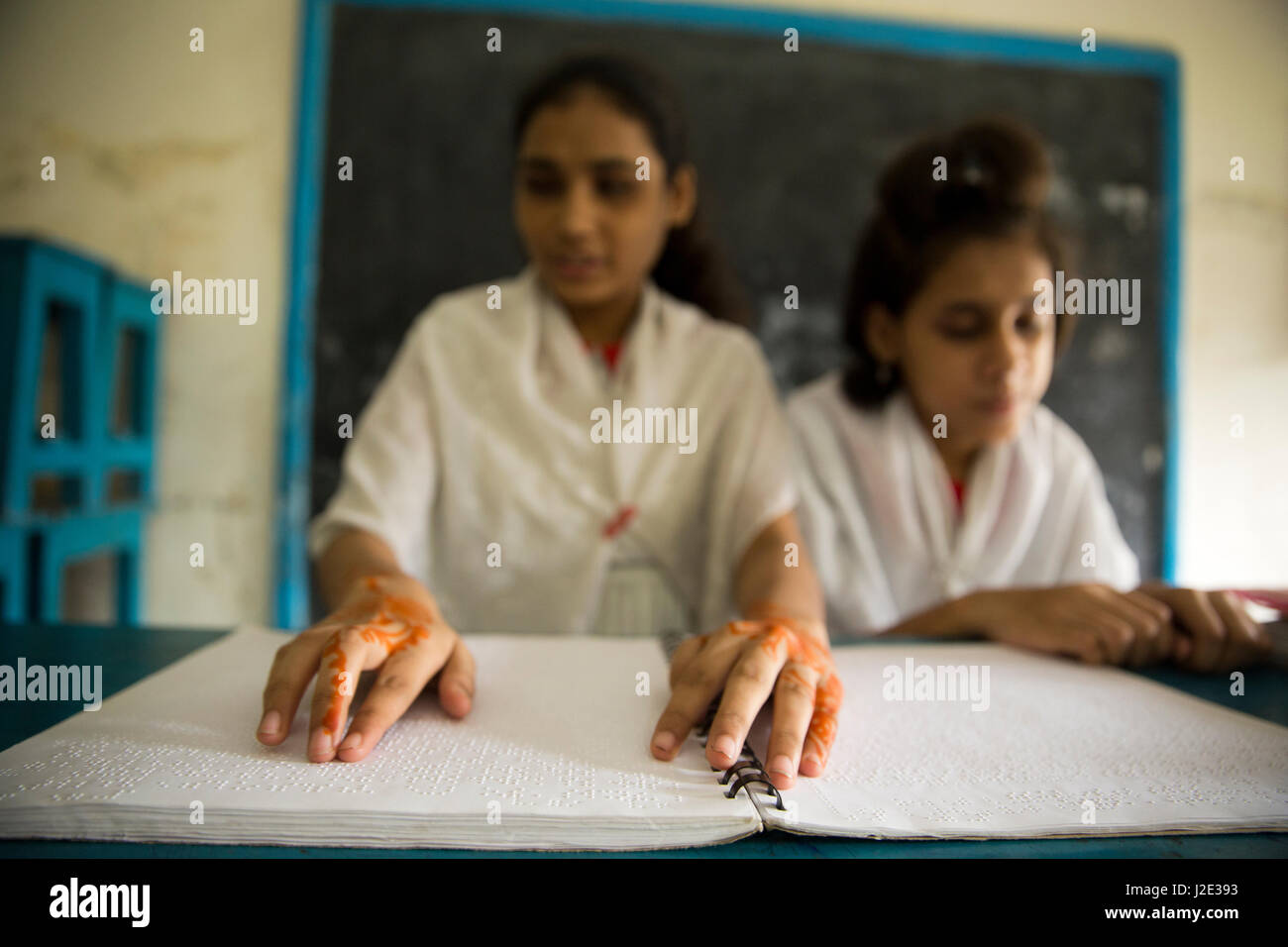 Visually impaired girl students learn in classroom with the help of