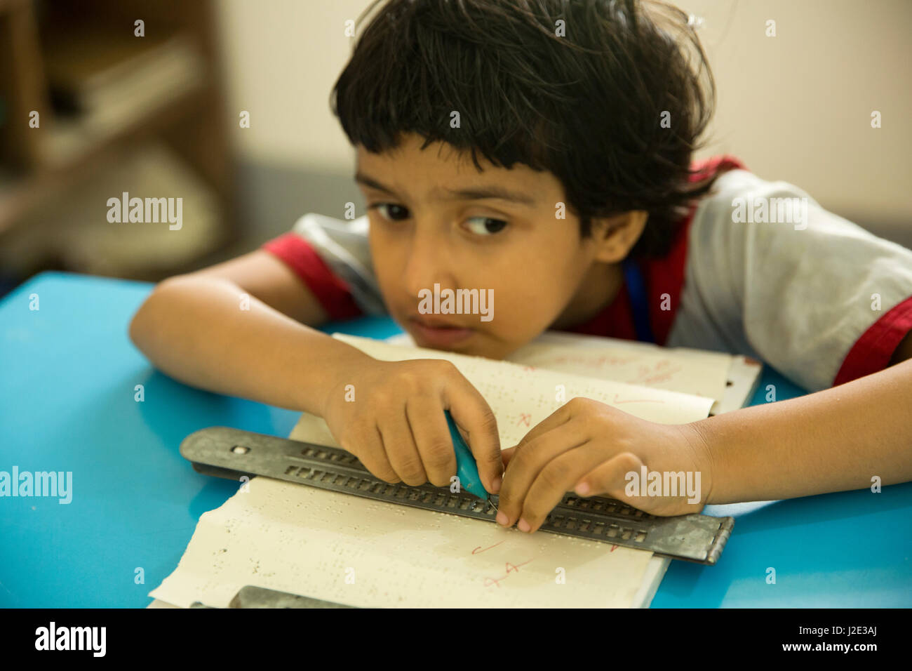 Visually impaired girl student learns in classroom with the help of