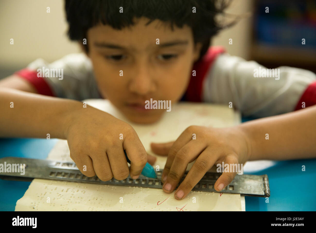 Visually impaired girl student learns in classroom with the help of