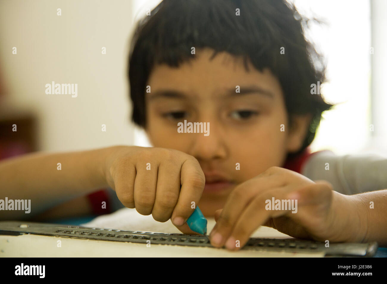 Visually impaired girl student learns in classroom with the help of