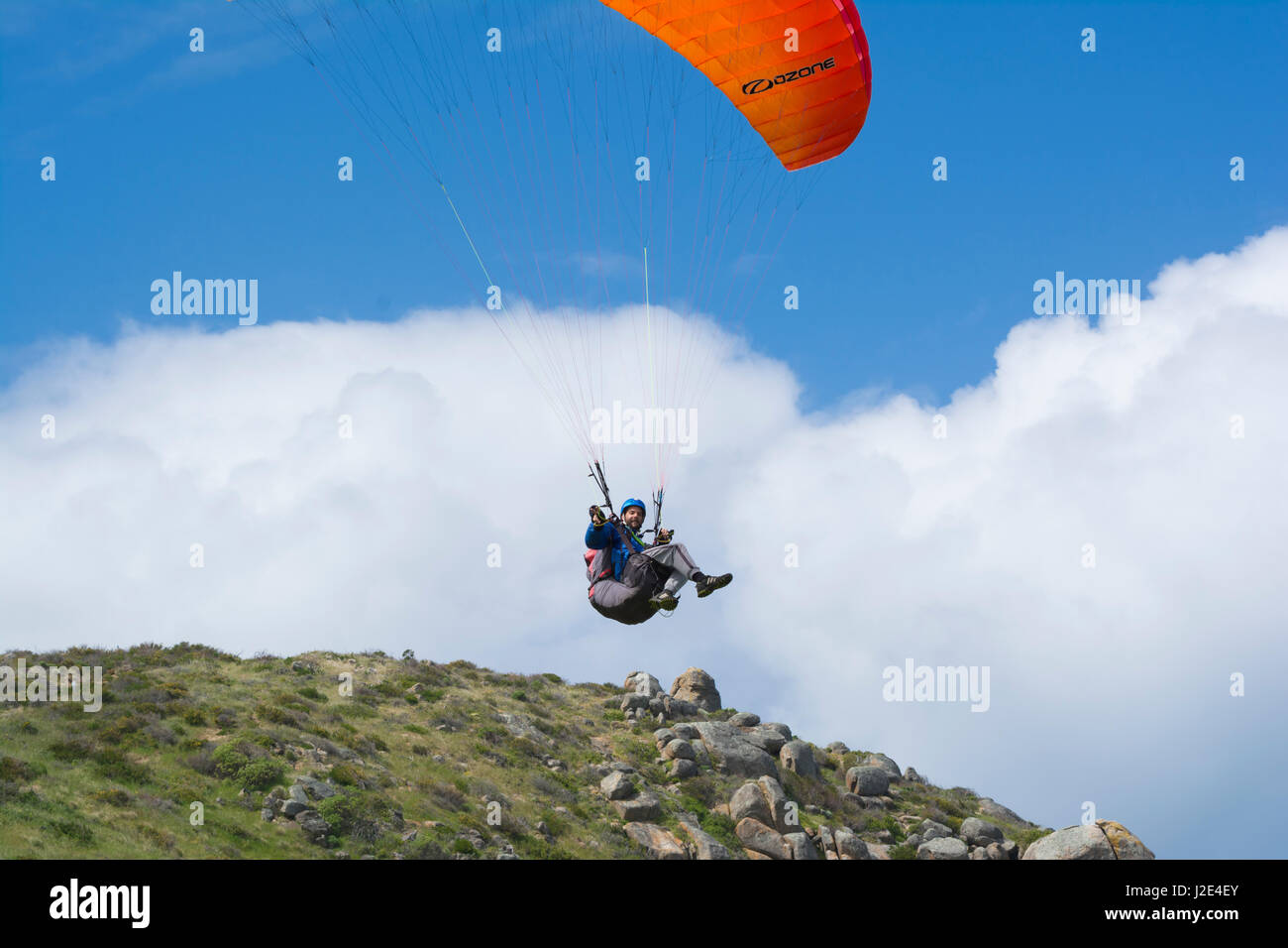 Victor Harbor, South Australia, Australia - November 11, 2016: Random male paraglider posing for us and looking straight into the camera whilst flying Stock Photo