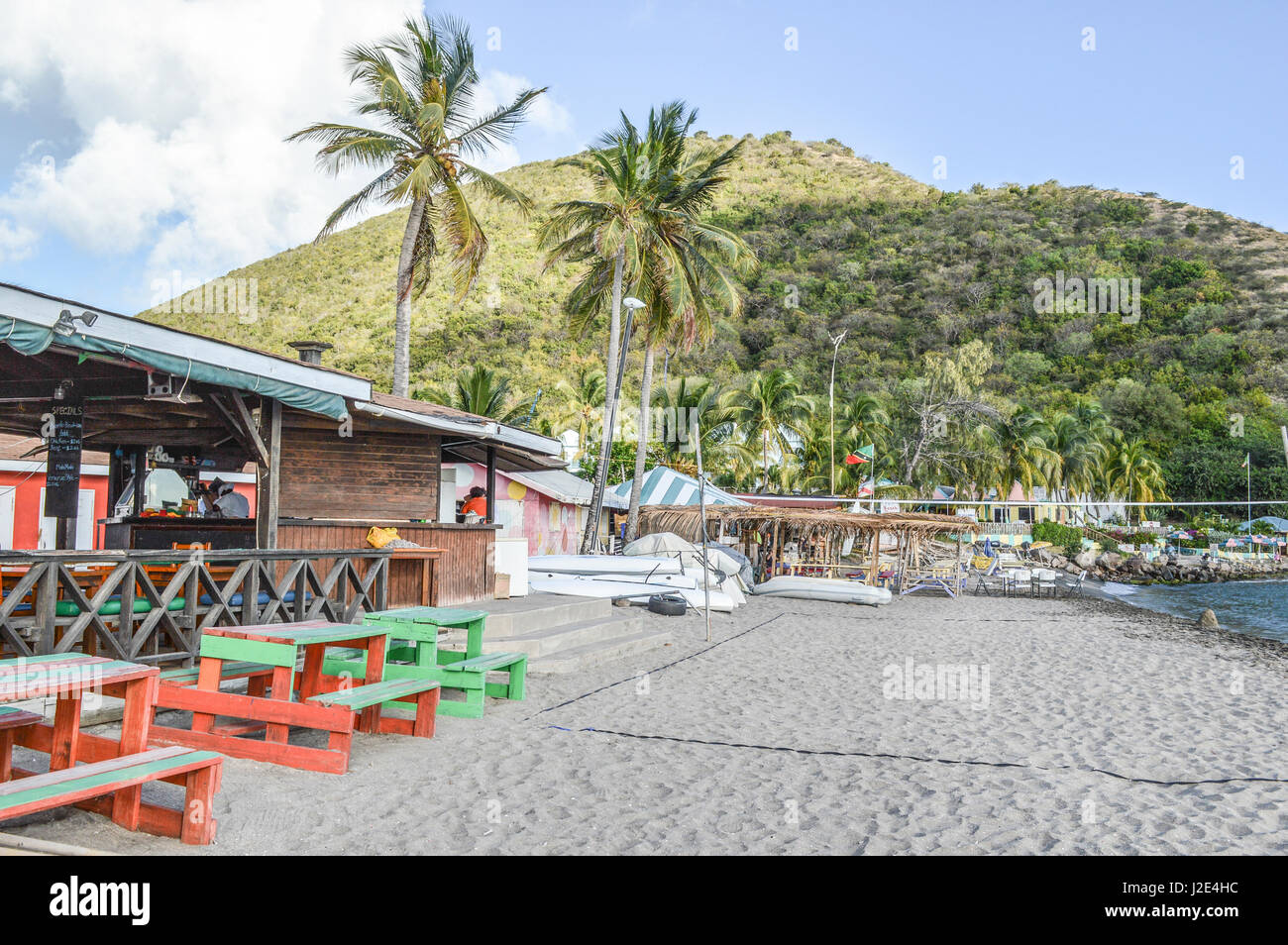 Volleyball net set up next to restaurants on the beach in St-Kitts-Nevis Stock Photo