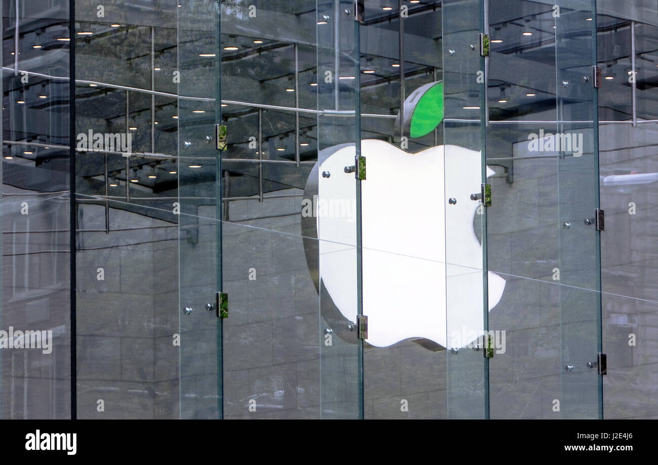 Apple corporate logo inside their store on Broadway and 67th street has its leaf illuminated green. Stock Photo