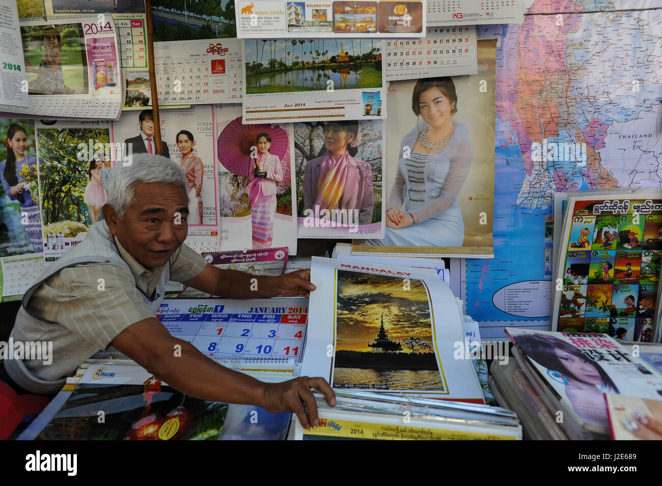 20.12.2013, Yangon, Republic of the Union of Myanmar, Asia - A street vendor sells calenders and posters with the picture of Aung San Suu Kyi. Stock Photo