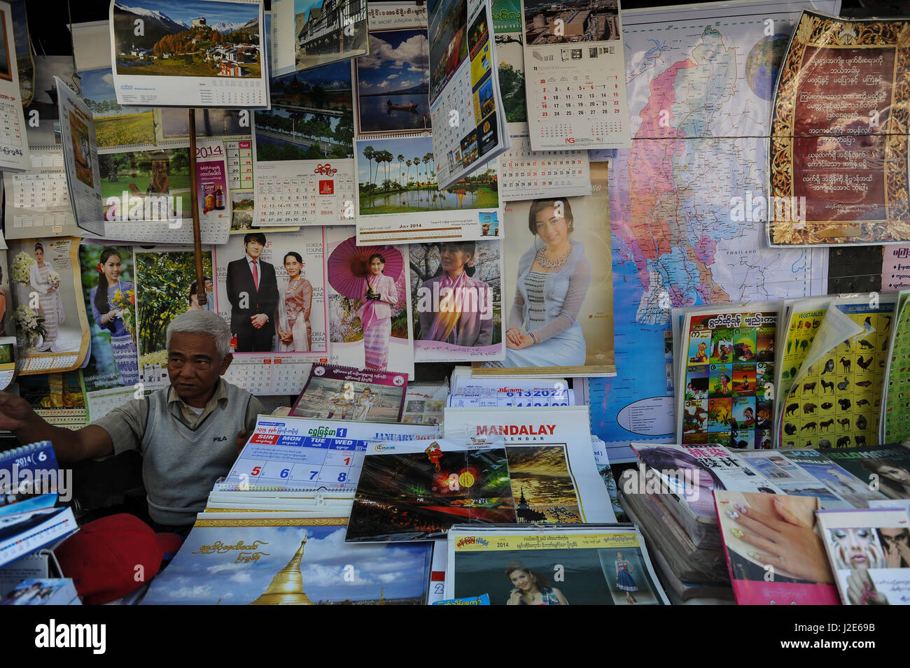 20.12.2013, Yangon, Republic of the Union of Myanmar, Asia - A street vendor sells calenders and posters with the picture of Aung San Suu Kyi. Stock Photo