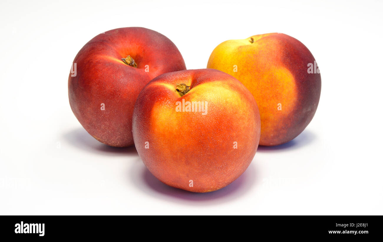 sweet freshness of nectarines, peach isolated on white background Stock