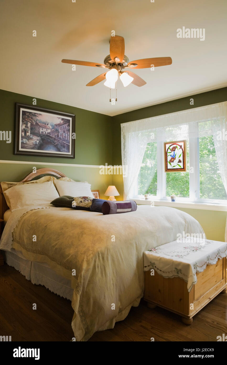 Bed and trunk chest in the master bedroom inside a cottage style