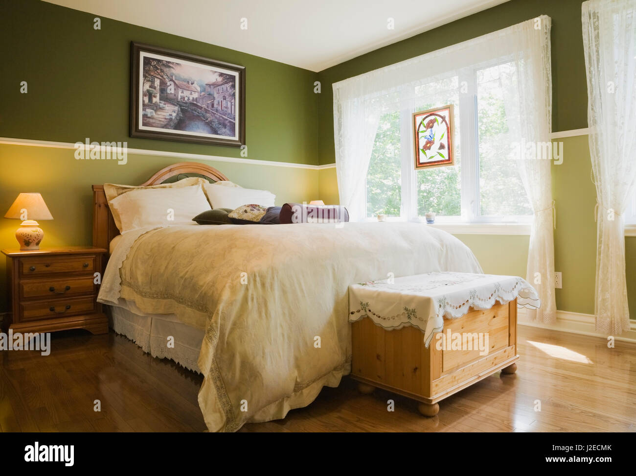 Bed and trunk chest in the master bedroom inside a cottage style