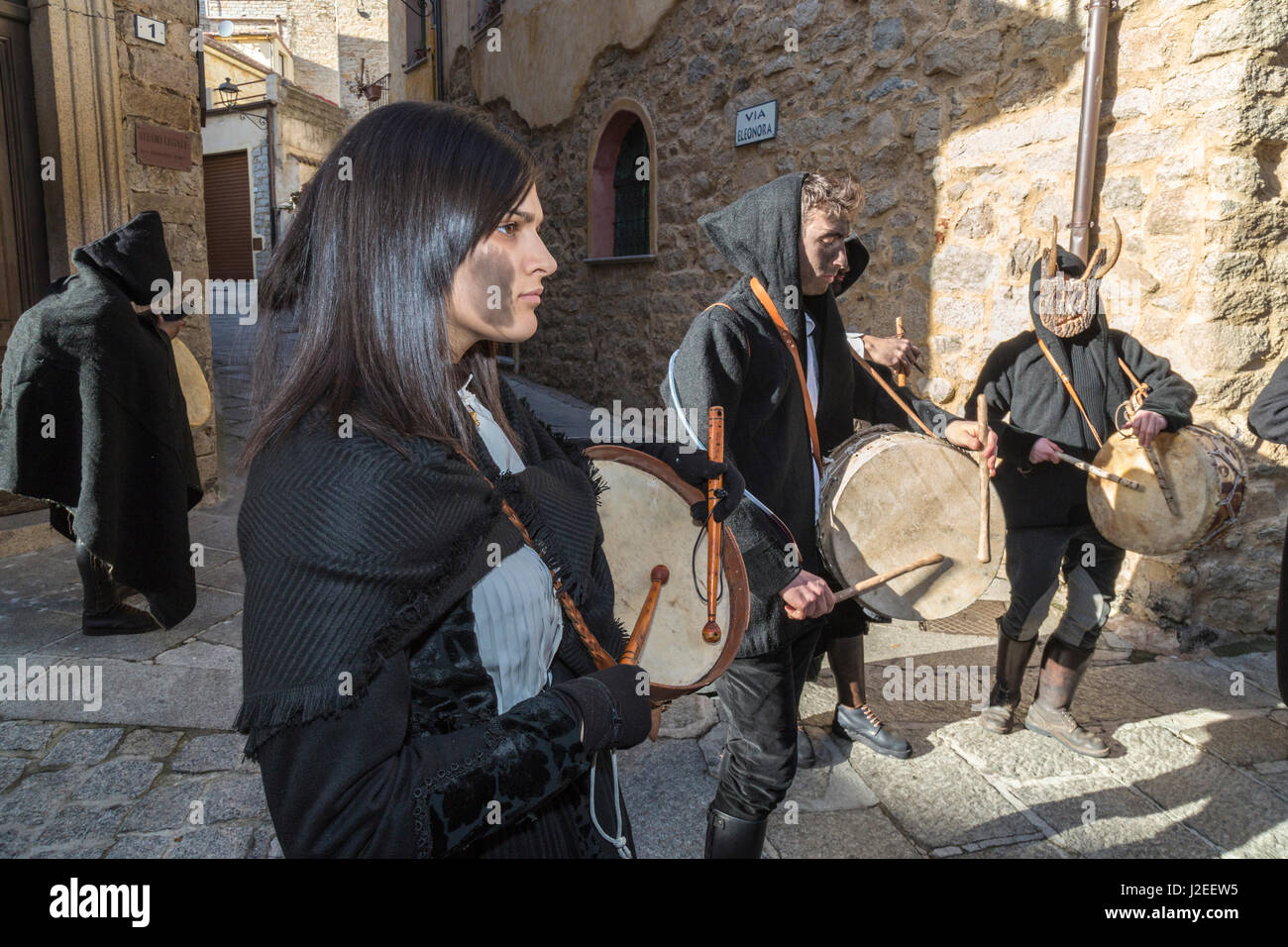 Italy, Sardinia, Gavoi. Townspeople playing drums and covered in cork soot, part of a traditional pagan celebration. Stock Photo