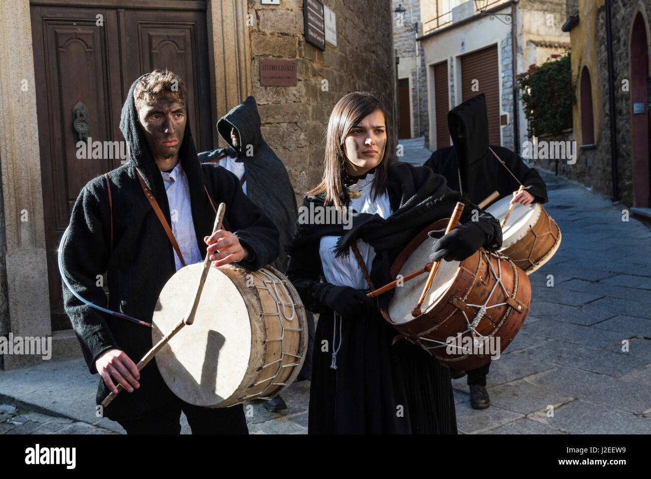 Italy, Sardinia, Gavoi. Townspeople playing drums and covered in cork soot, part of a traditional pagan celebration. Stock Photo