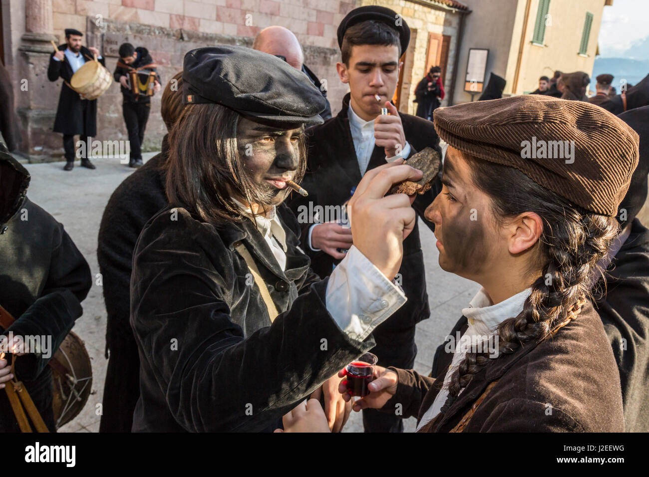 Italy, Sardinia, Gavoi. Townspeople covering each other in cork soot, part of a traditional pagan celebration. Stock Photo