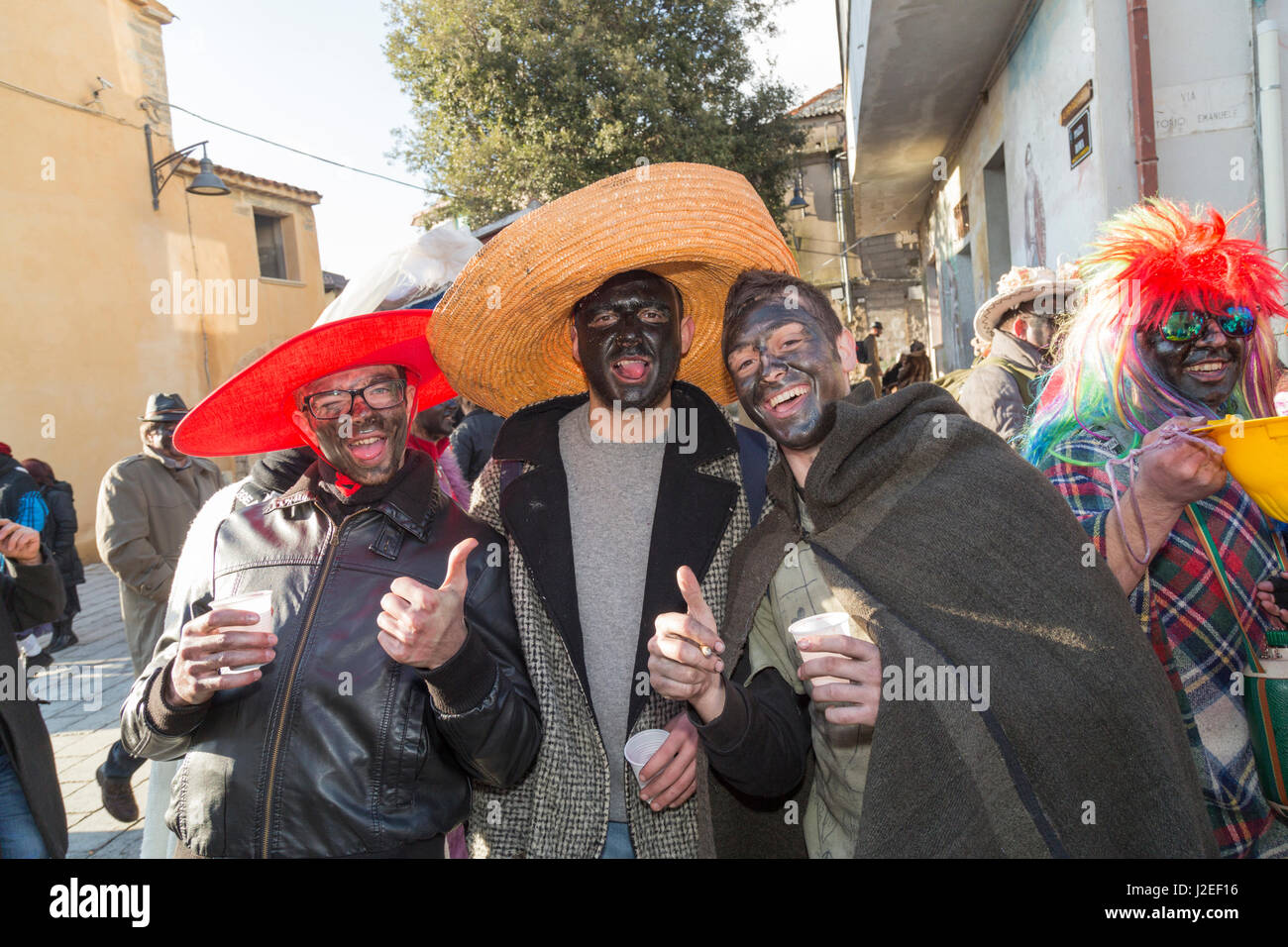 Italy, Sardinia, Ovodda. Costumed men with black painted faces at a pagan celebration. Stock Photo