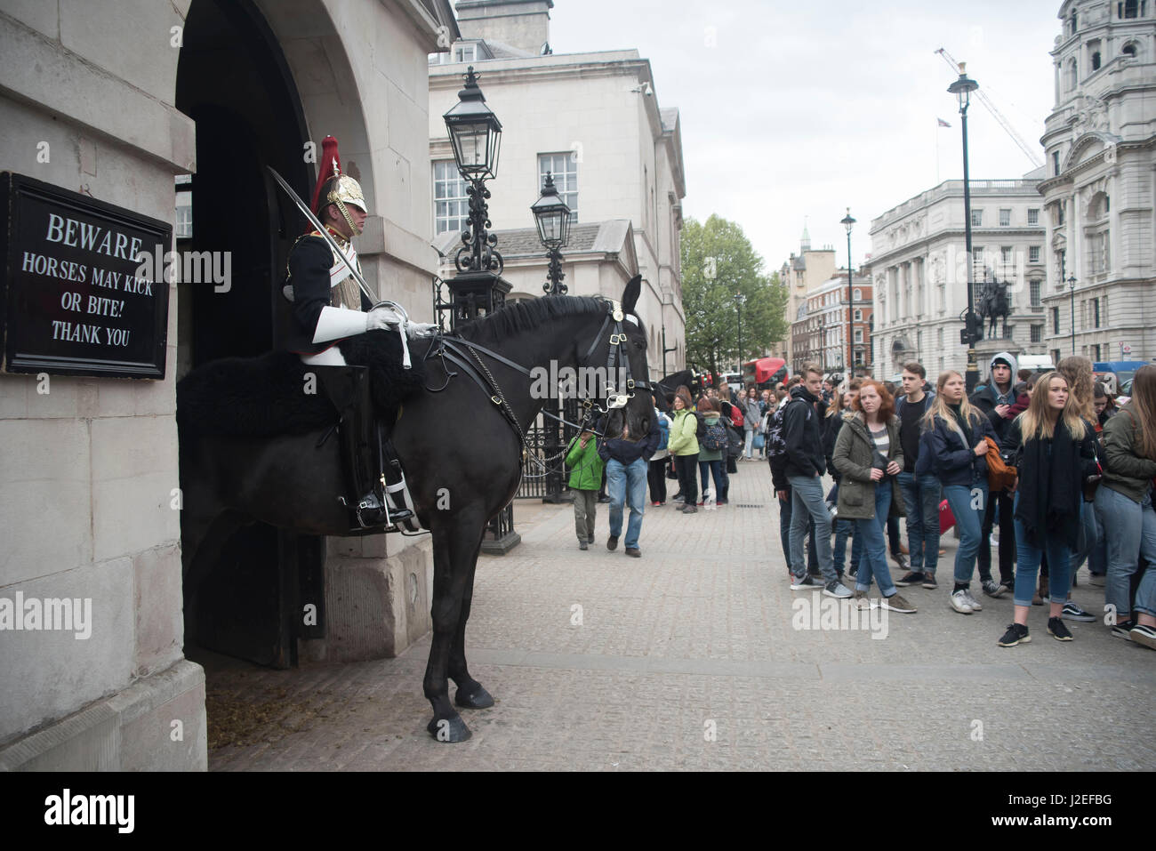 London, UK. 27th Apr, 2017. The Queen's life guards are pictured at the Horse Guards Parade while on duty. Several tourists stop to see them and take pictures. Credit: Alberto Pezzali/Pacific Press/Alamy Live News Stock Photo