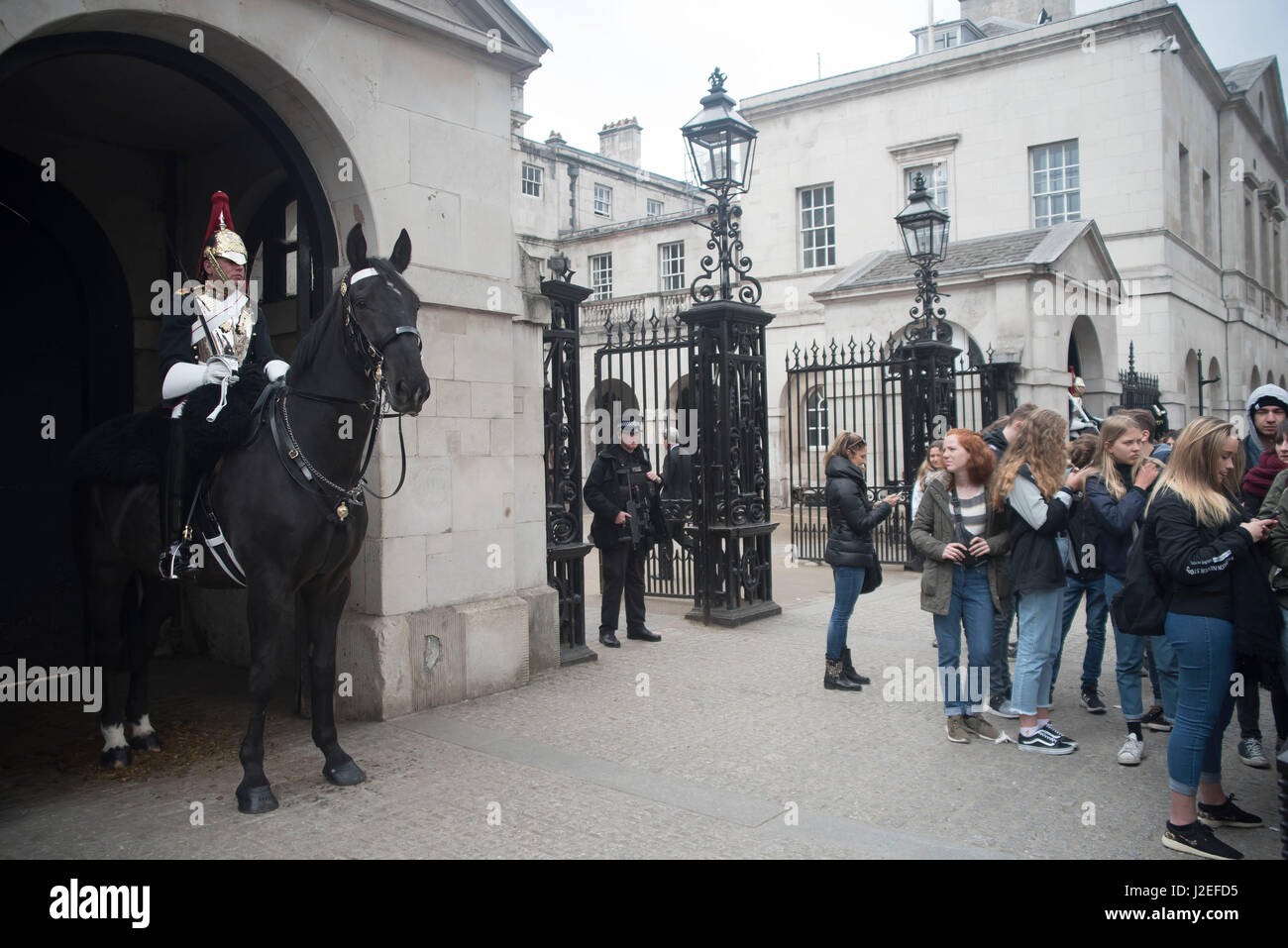 London, UK. 27th Apr, 2017. The Queen's life guards are pictured at the Horse Guards Parade while on duty. Several tourists stop to see them and take pictures. Credit: Alberto Pezzali/Pacific Press/Alamy Live News Stock Photo