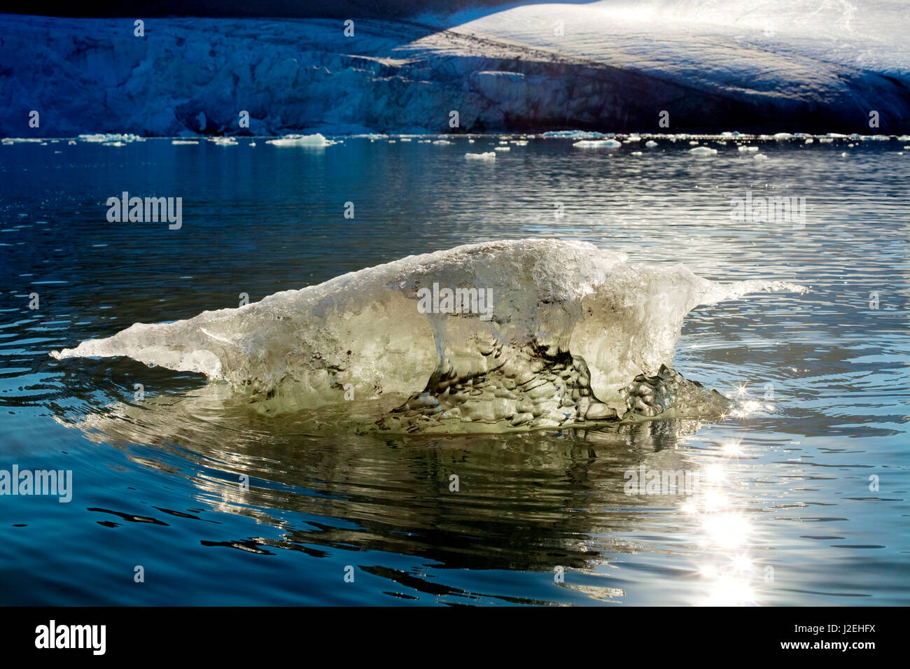 Arctic, Svalbard. Mud laden iceberg from a glacier melts after calving into the sea. Stock Photo