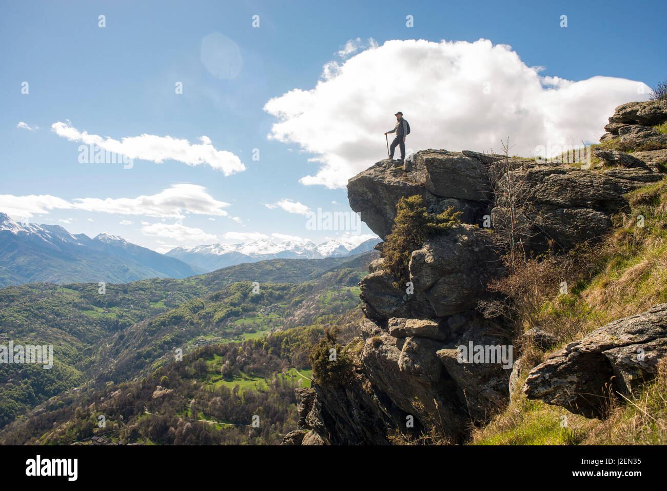 Man Standing on Top of Mountain with Panoramic View, Mocchie, Piedmont, Italy Stock Photo