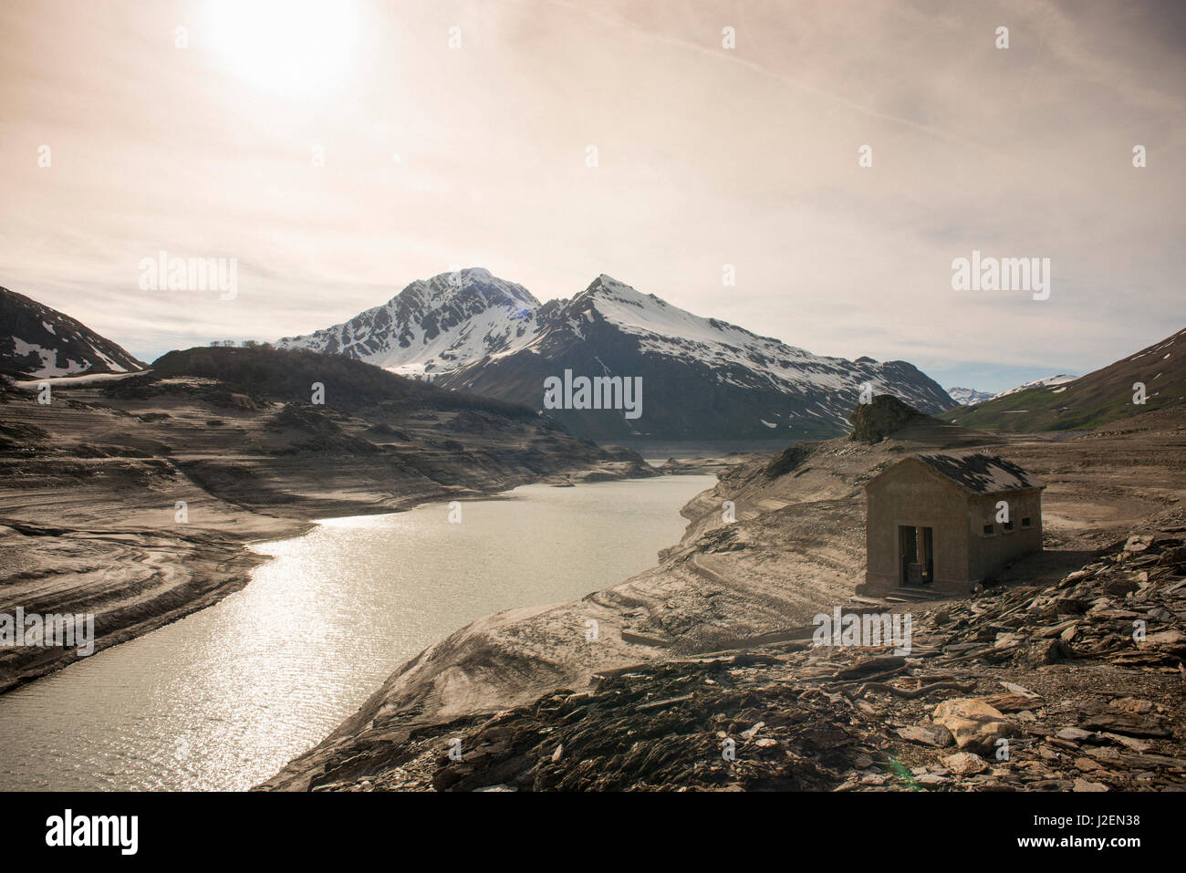 Small Building Exposed after Draining of Mountain Dam, Val Cenis Vanoise, France Stock Photo