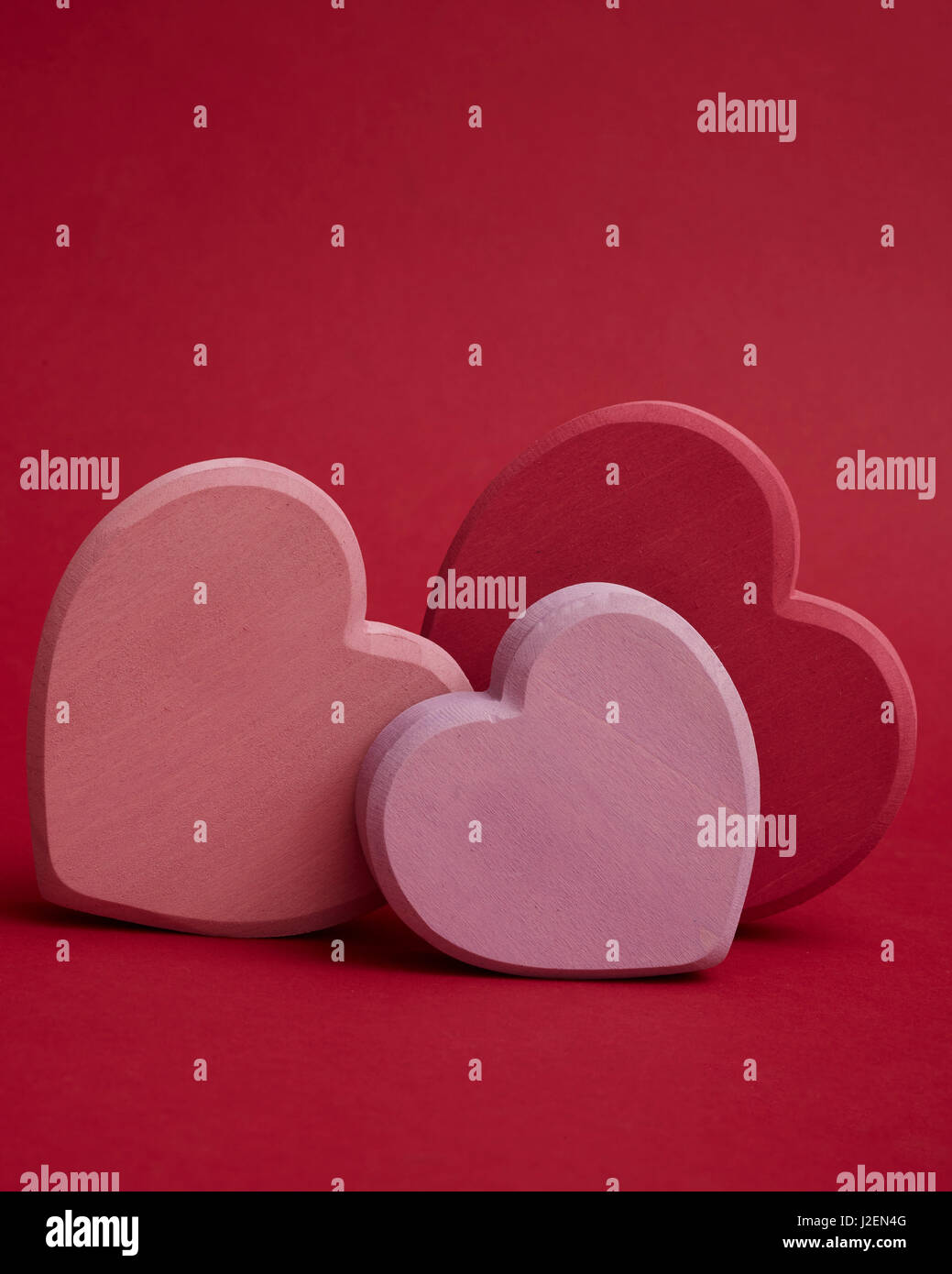 Three Hearts on Red Background Stock Photo
