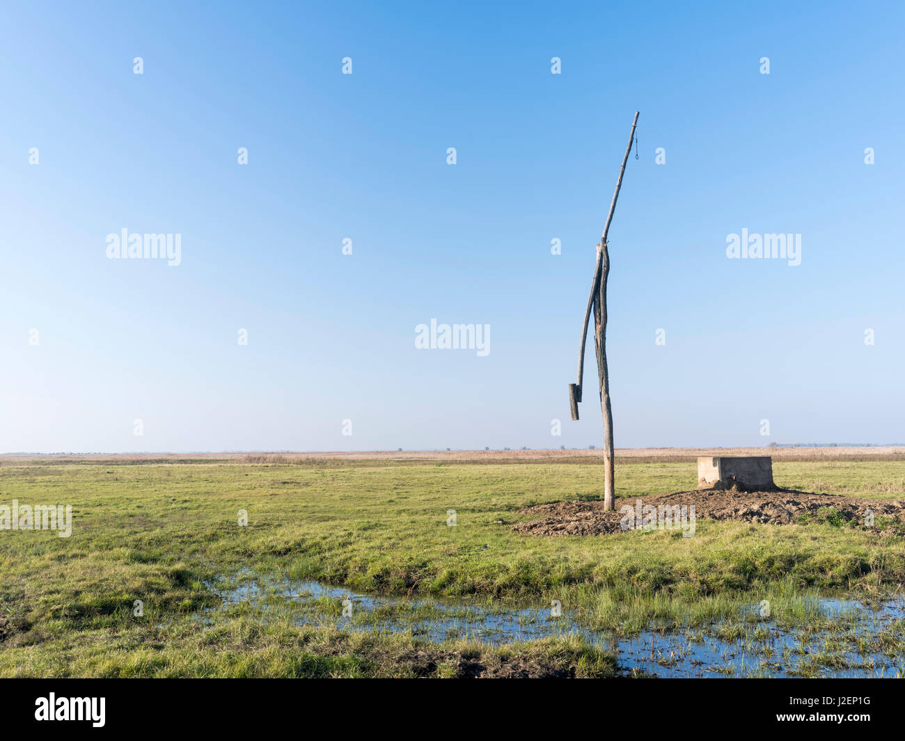 Traditional water well (well sweep or shadoof) in the Hungarian lowland plains also called Puszta in the Hotobagy National Park, which is listed as UNESCO world heritage Hungary, November (Large format sizes available) Stock Photo