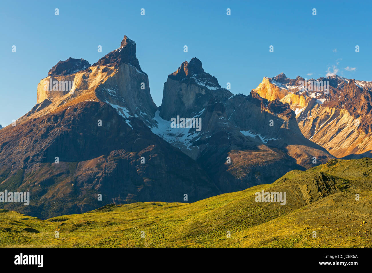 The Andes mountain peaks of the Cuernos del Paine inside the Torres del Paine national park at sunset near Puerto Natales, Patagonia, Chile. Stock Photo