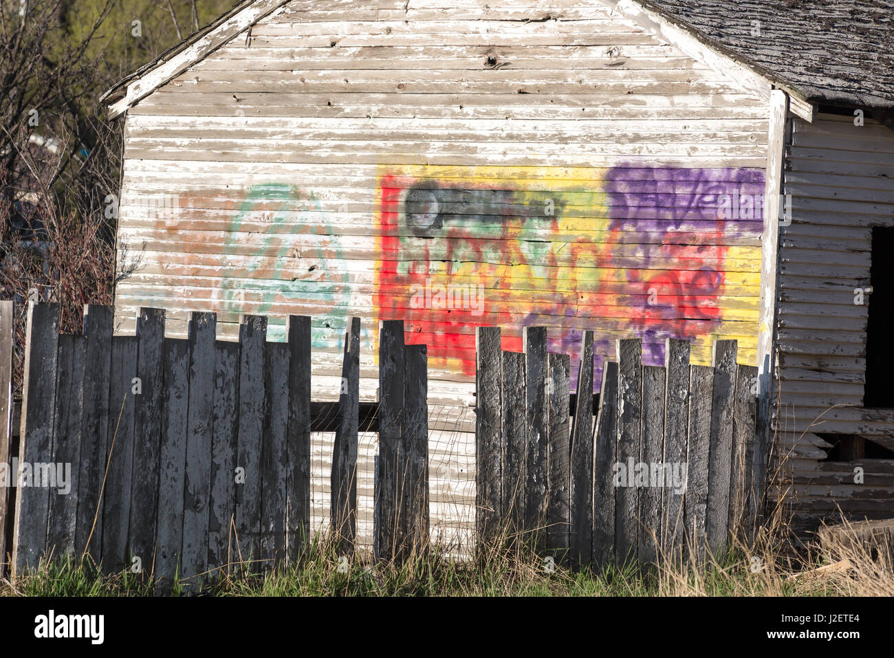 Fence and garage with painted over graffiti in Enterprise, Oregon Stock