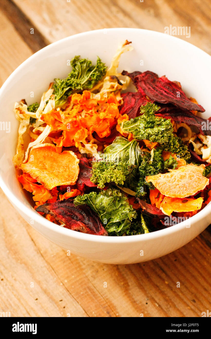 Oven cooked vegetable chips with lettuce, potatoes, basil and herbs