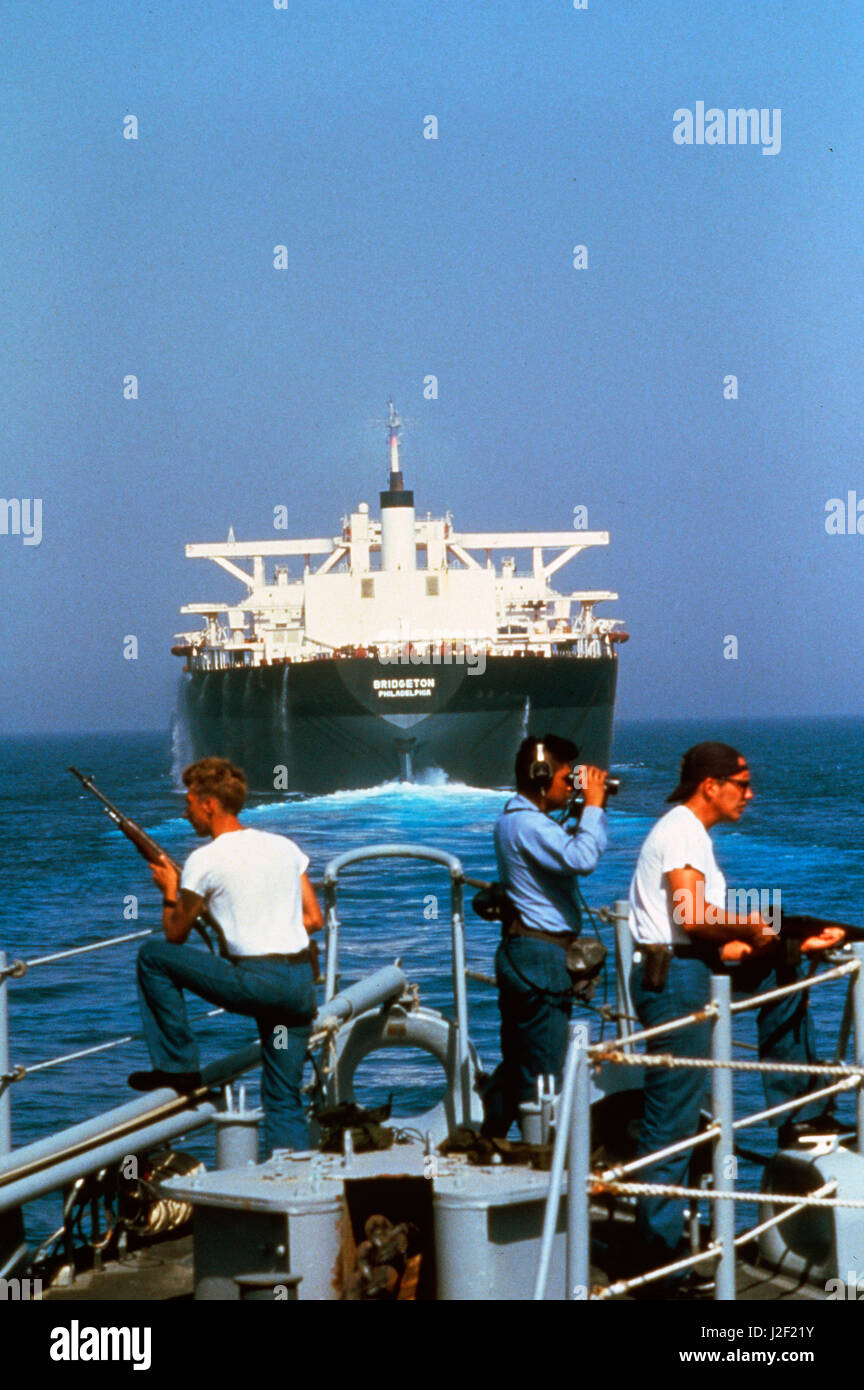 Sailors on the bow of the USS Fox look for mines as the USS Fox fell in ...