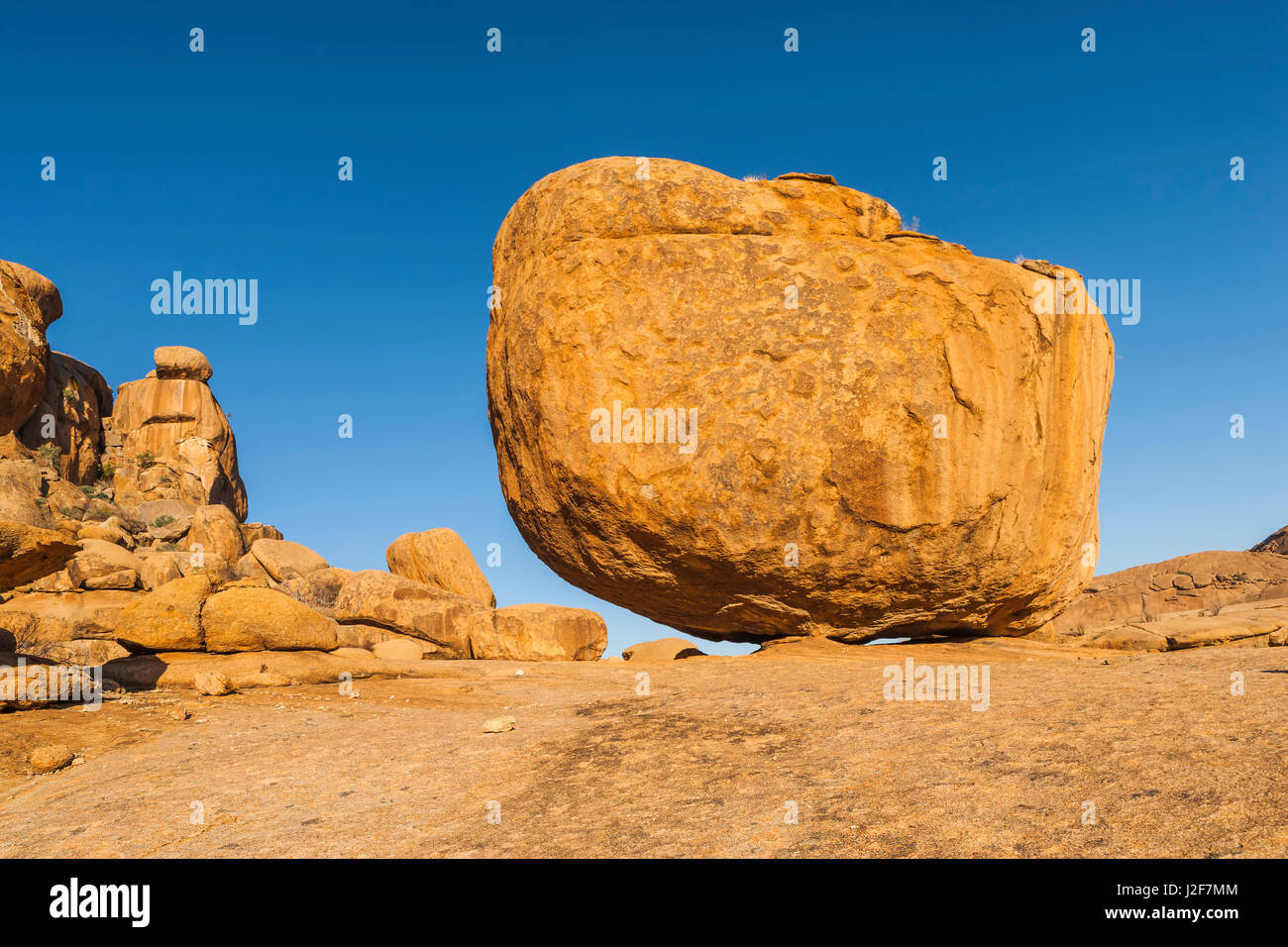 Enormous granite boulder against blue sky Stock Photo