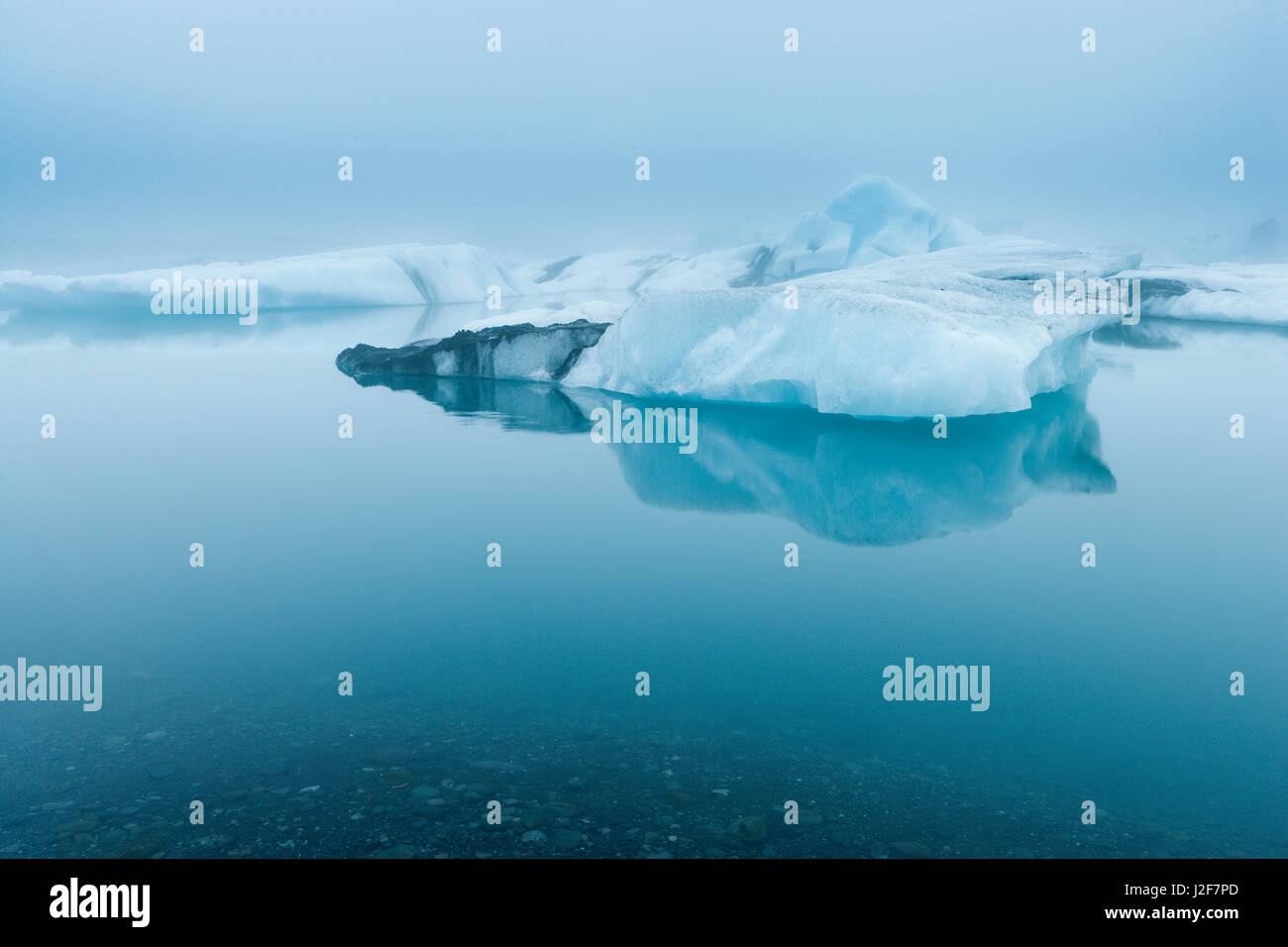 Landscape with icebergs in the foggy glacial lake JÃ¶kulsarlon Stock Photo