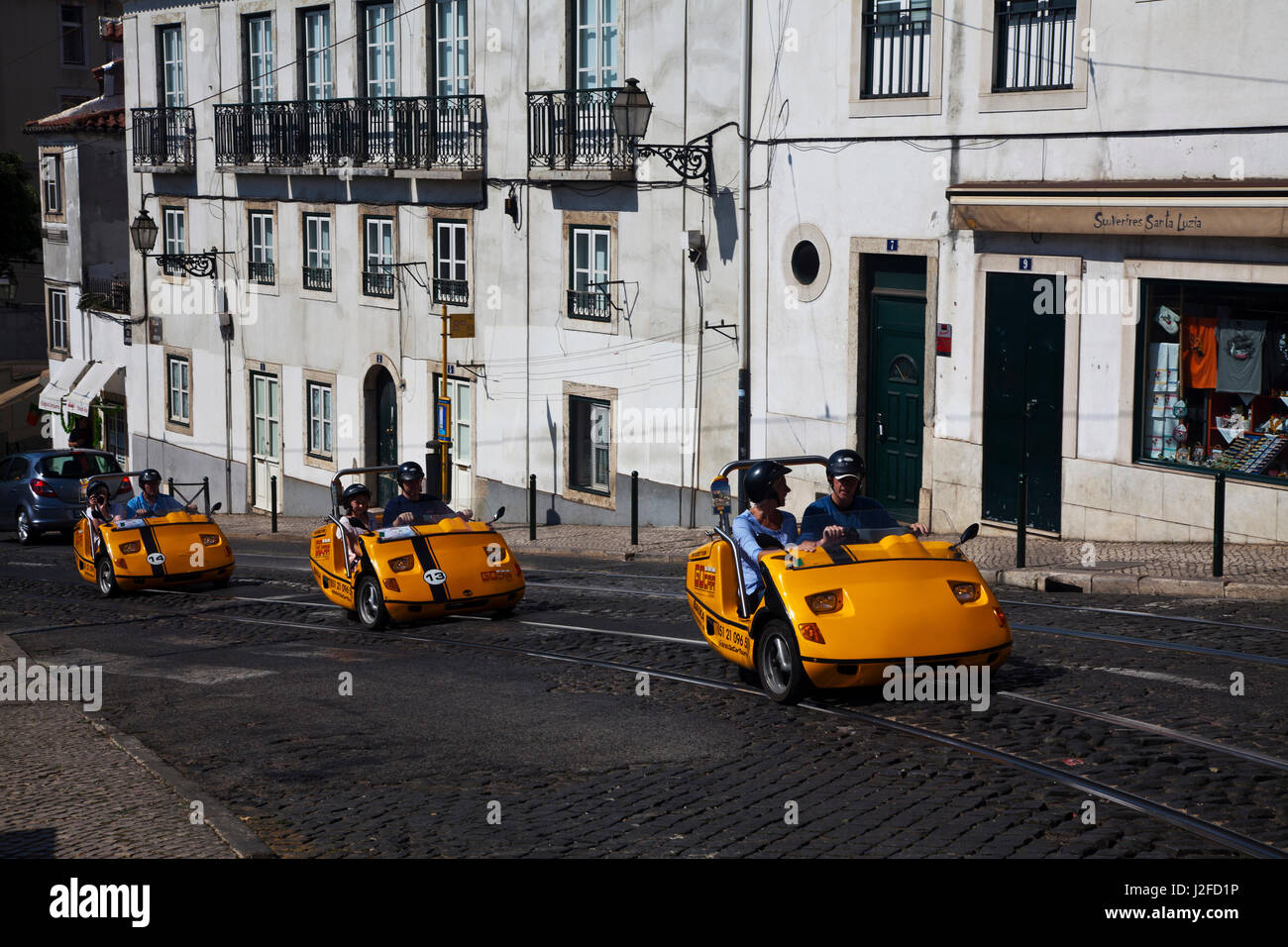 Portugal, Lisbon. Small rental three wheel cars on streets of Lisbon Stock Photo