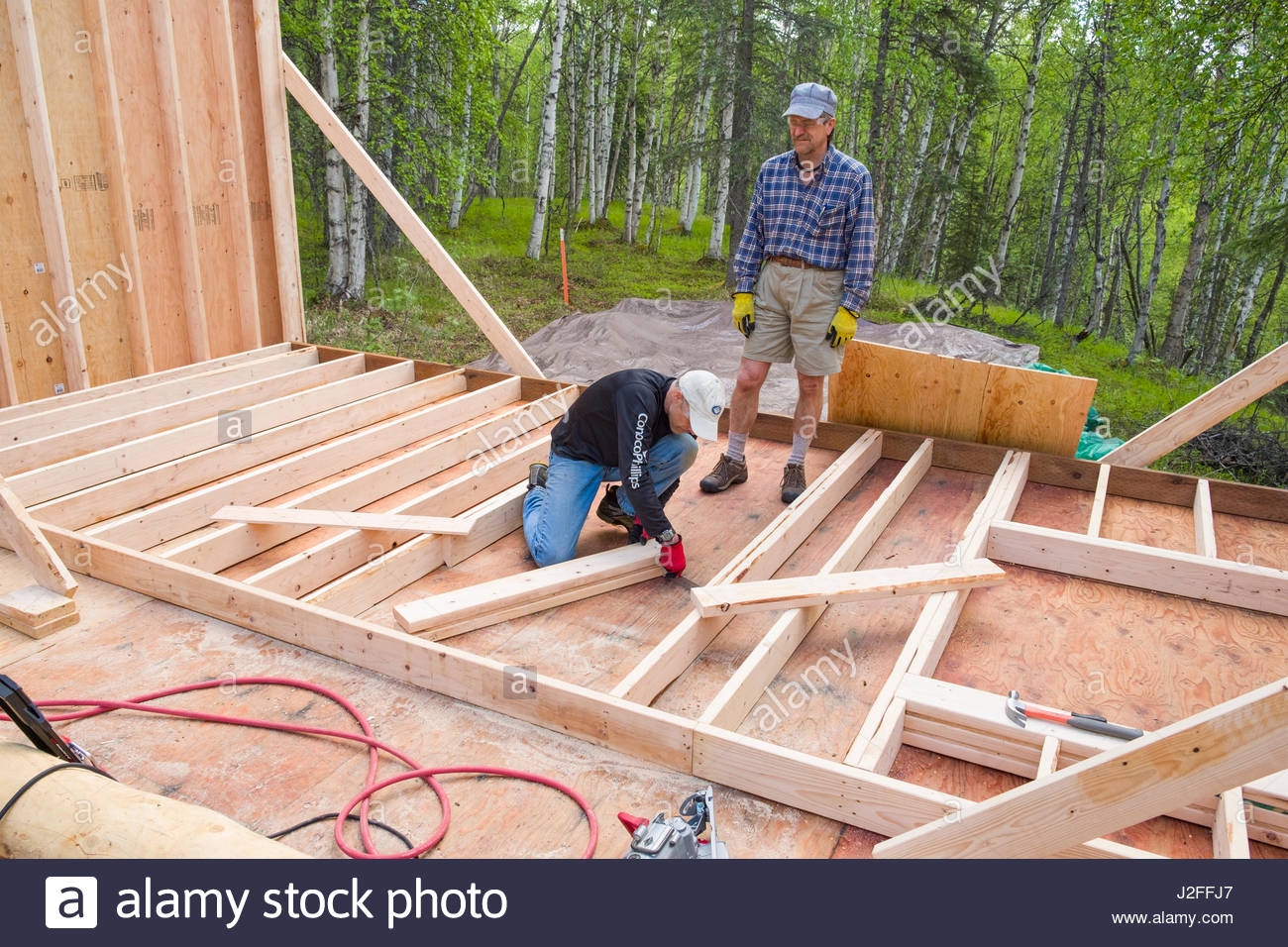 Men Building Wall For Remote Alaskan Cabin Matanuska Susitna