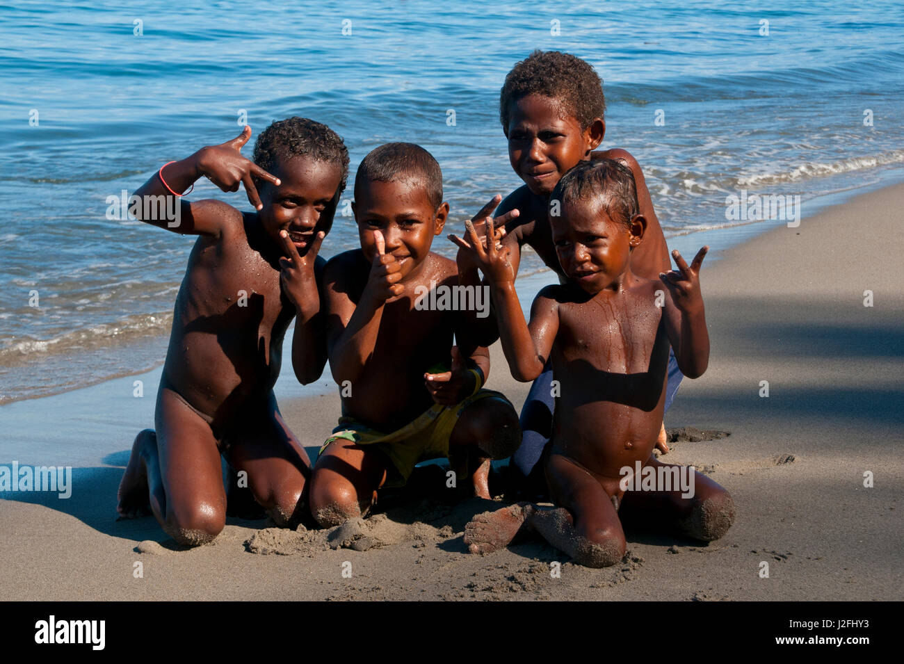 Happy children playing on the beach of Savo Island, Solomon Islands, Pacific Stock Photo