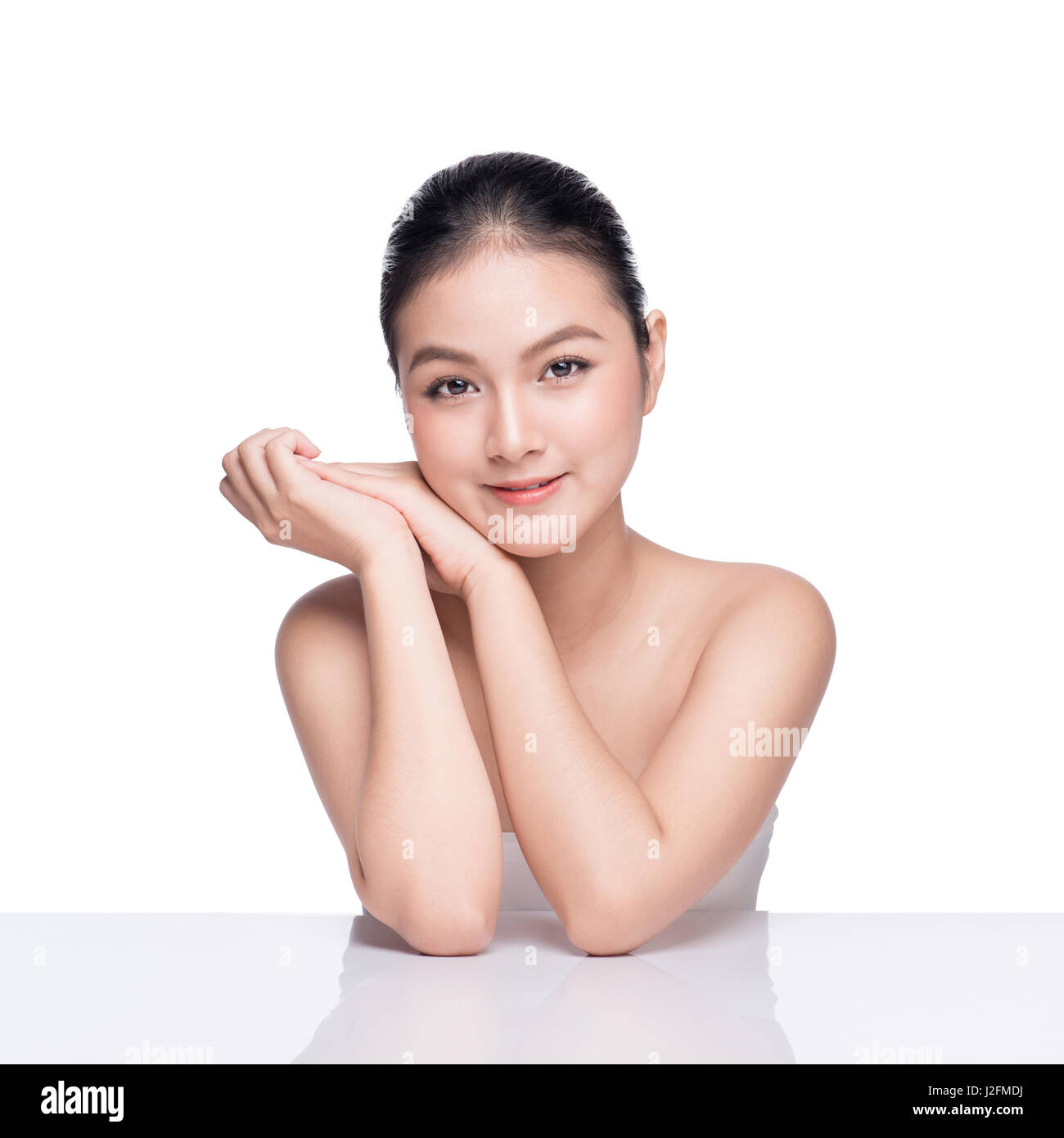 Facial treatment. Beautiful Young Asian Woman with Clean Fresh Skin