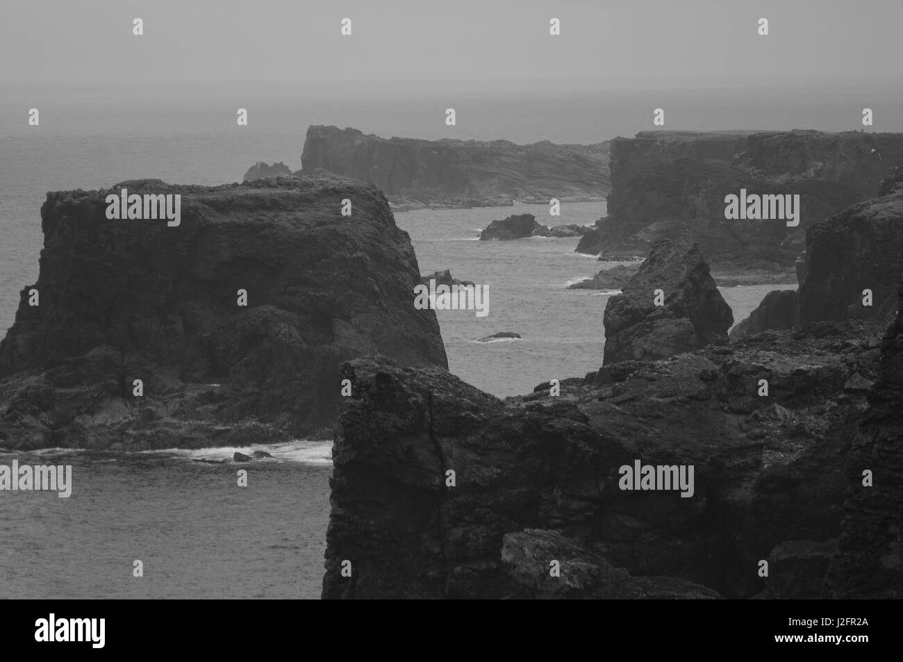 These moody cliffs are the Eshaness Cliffs in Shetland, Scotland.  This atmospheric location is one of the best Shetland attractions. Stock Photo